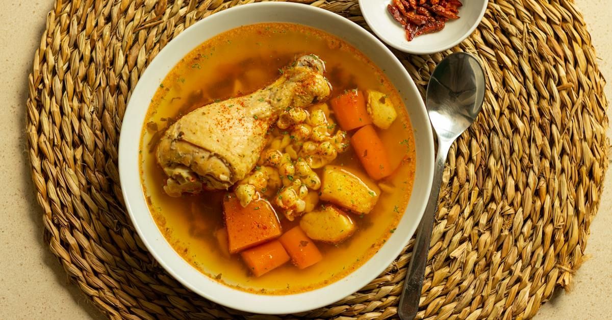 Nourishing bowl of rotisserie chicken soup with carrots, potatoes, and corn—perfect for postpartum recovery.