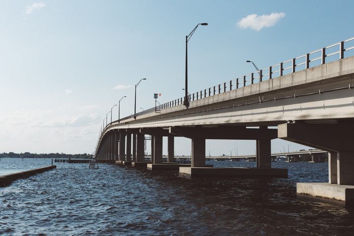 A bridge over water on a sunny day, with light blue sky.
