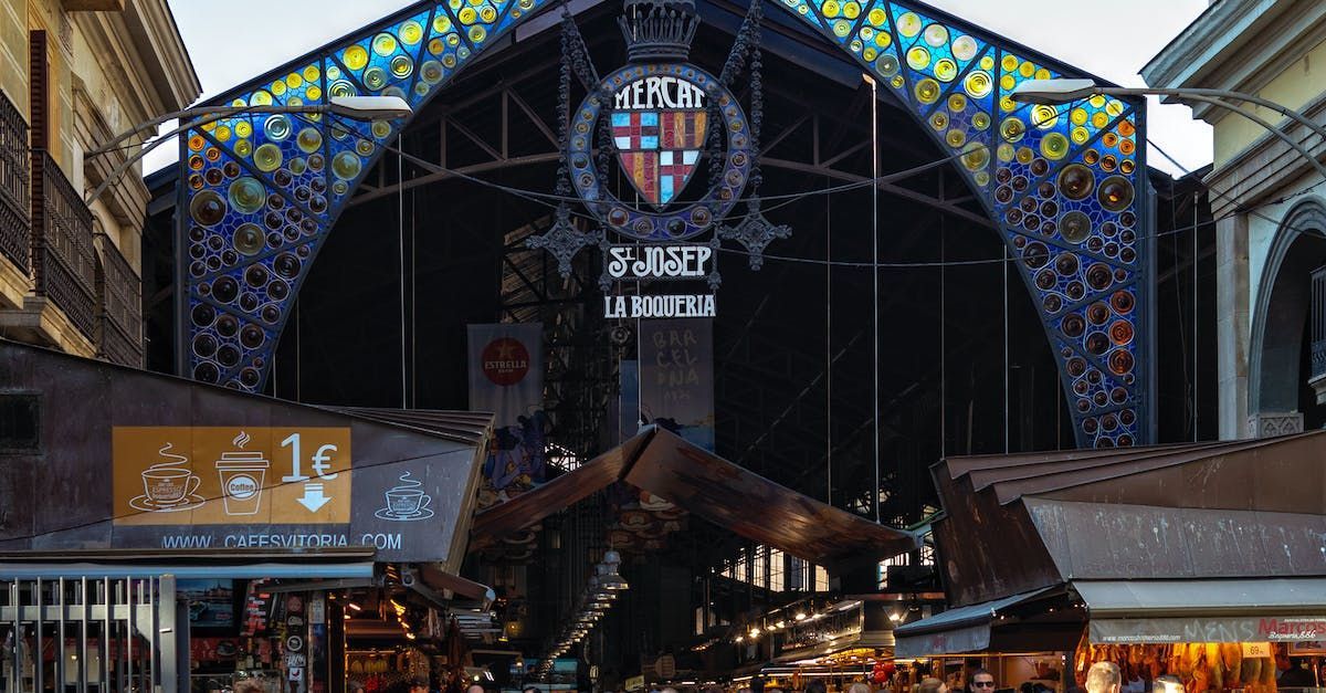 A market with a lot of shops and a stained glass entrance.