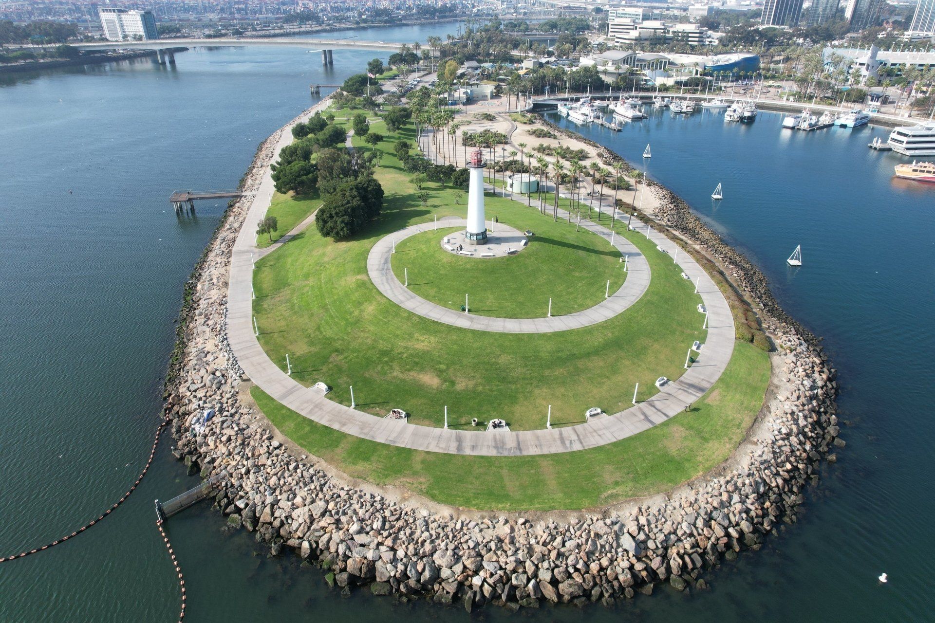 Aerial view of Rainbow Harbor park, a grassy peninsula with a spiral pathway, Long Beach, CA.