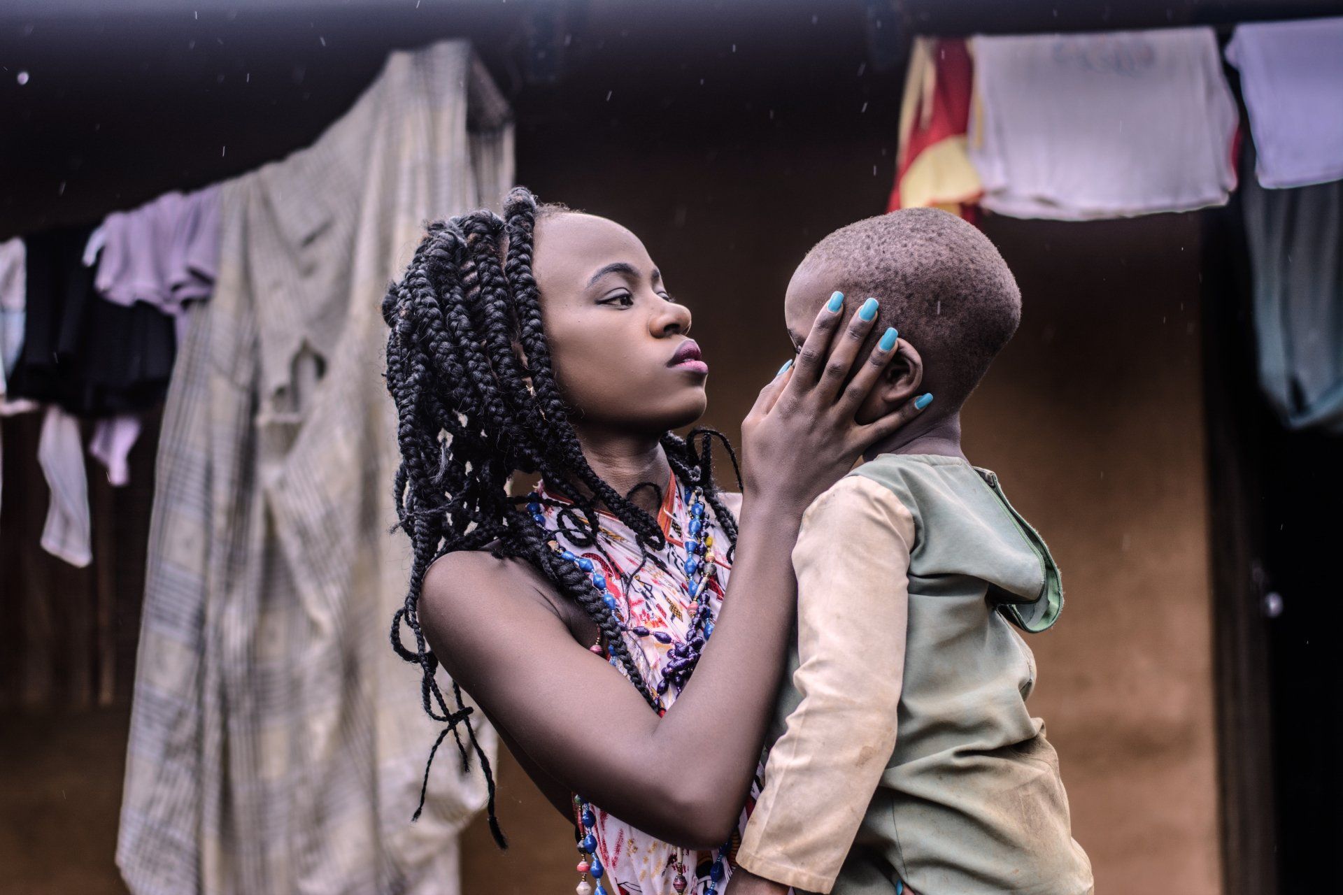 A woman is holding a small child in her arms.