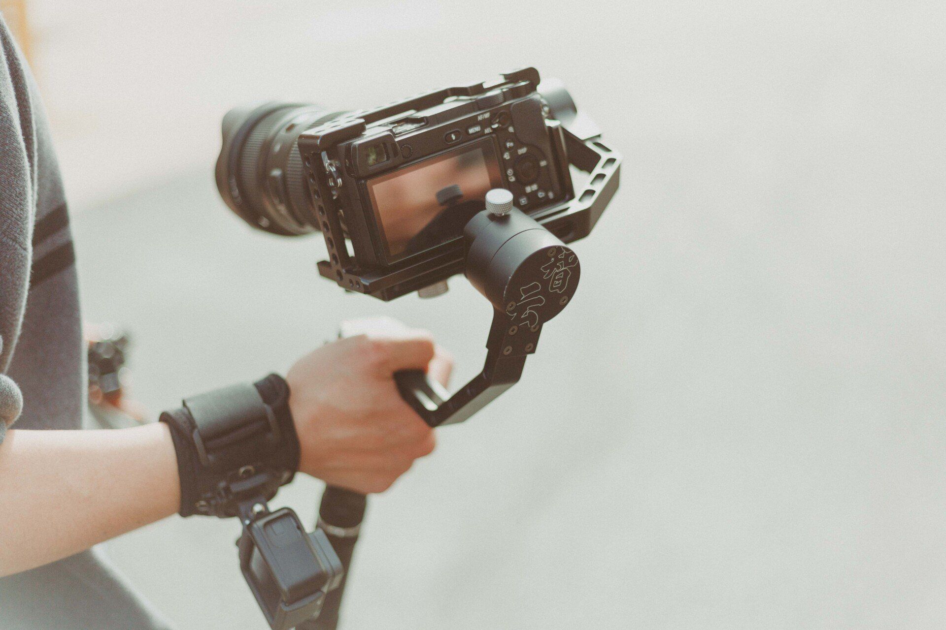 A person is holding a camera on a gimbal.