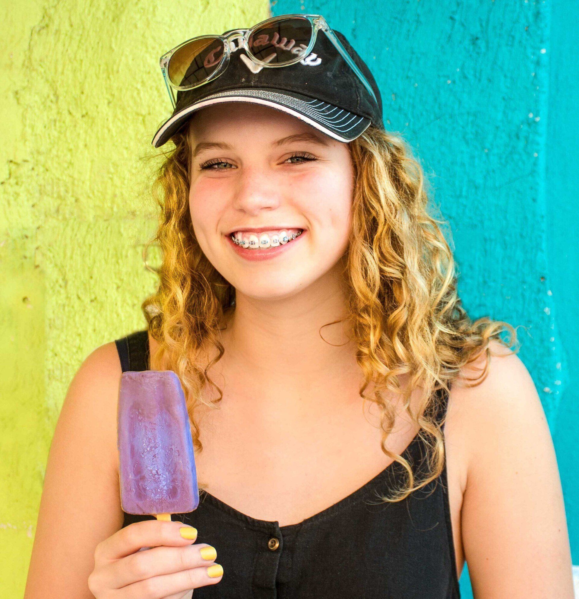 Girl with braces smiling at dentist