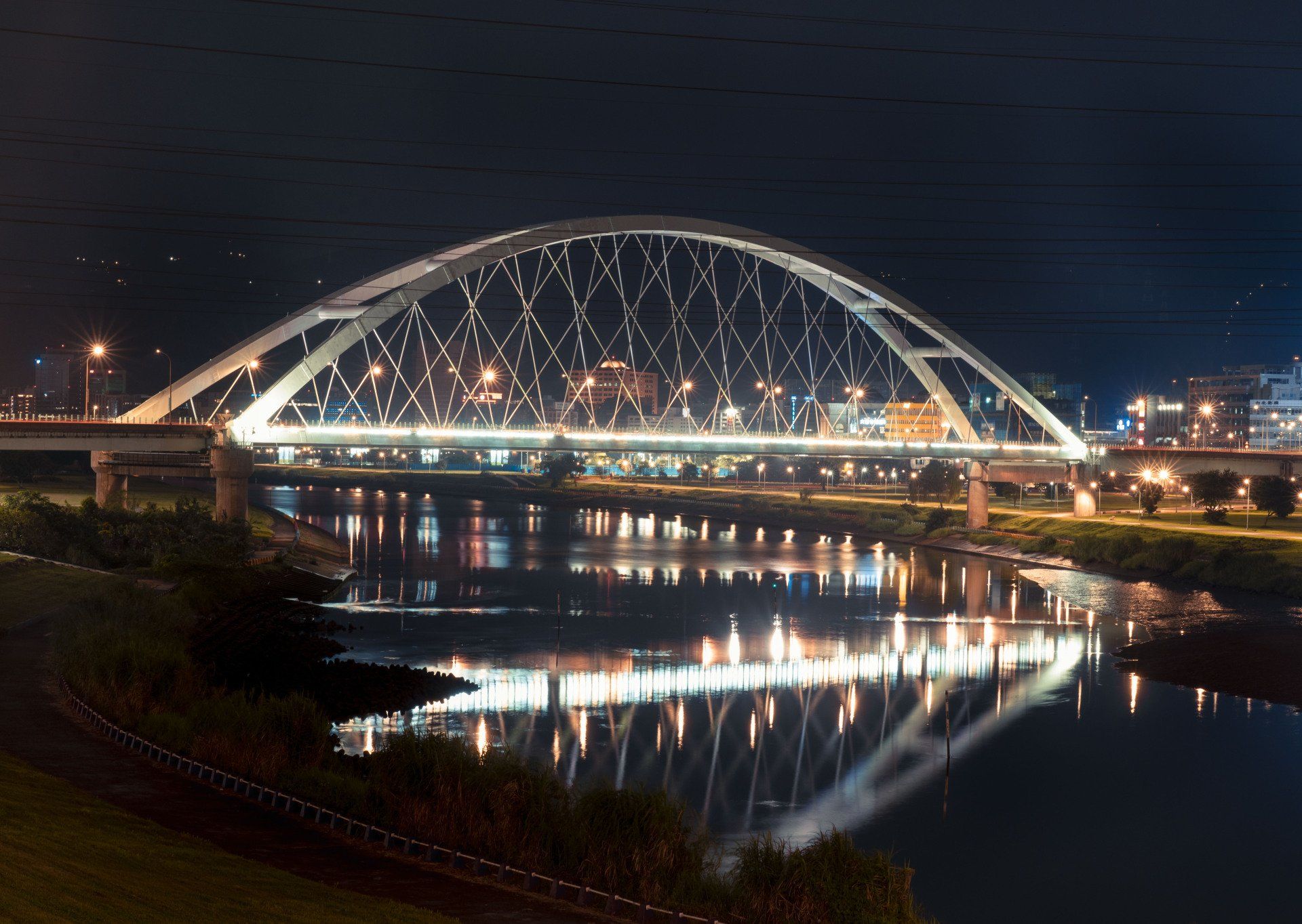 A bridge over a river is lit up at night in Edmonton. Business brokers Alberta | sell my manufacturing business in Canada. 