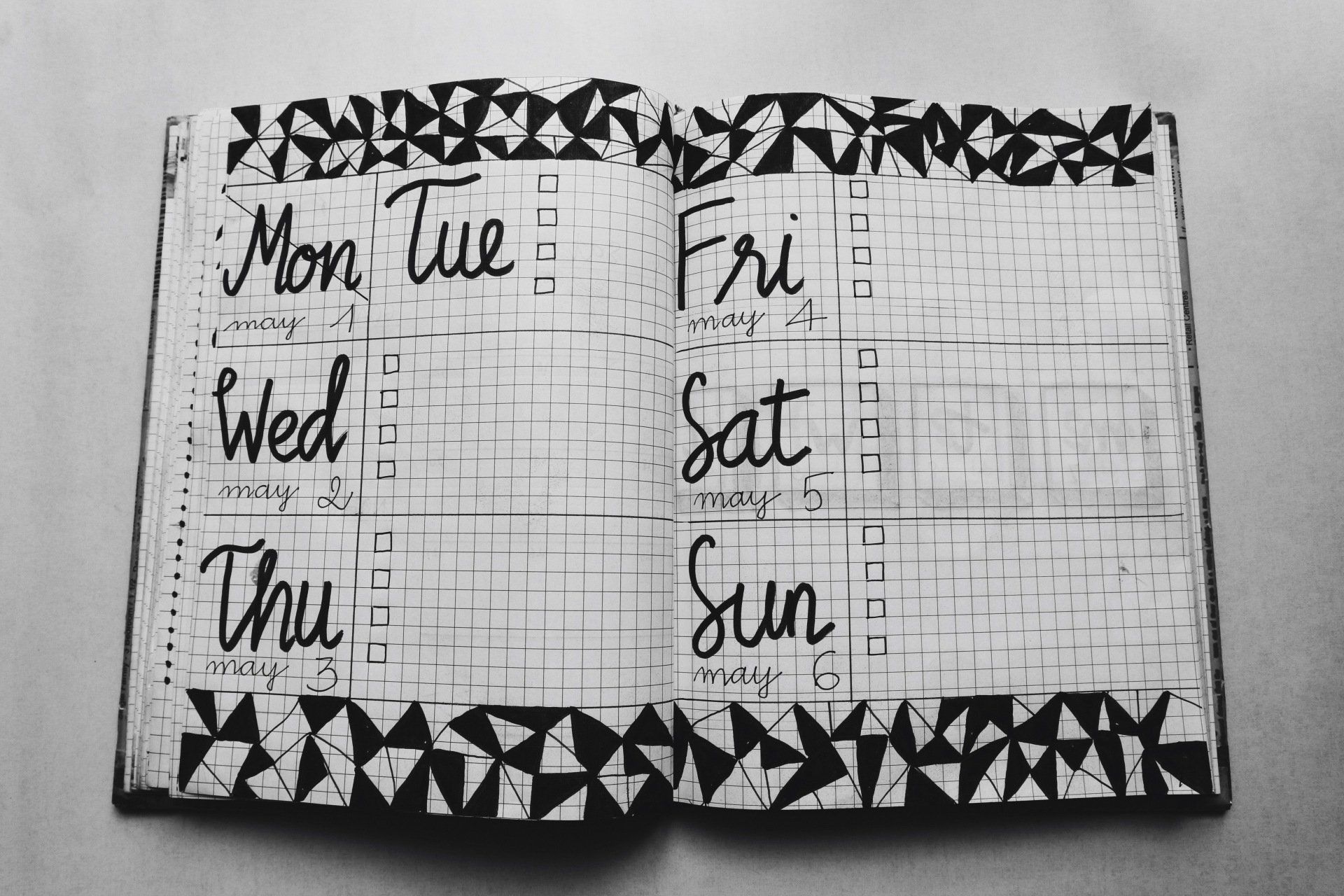 A notebook is open to a page with the days of the week written on it