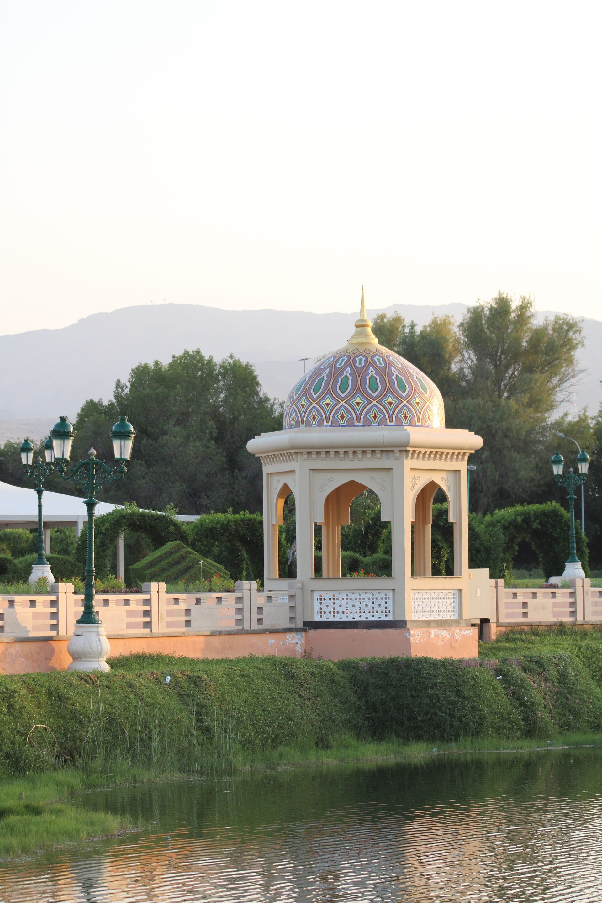 A gazebo sits on the shore of a lake