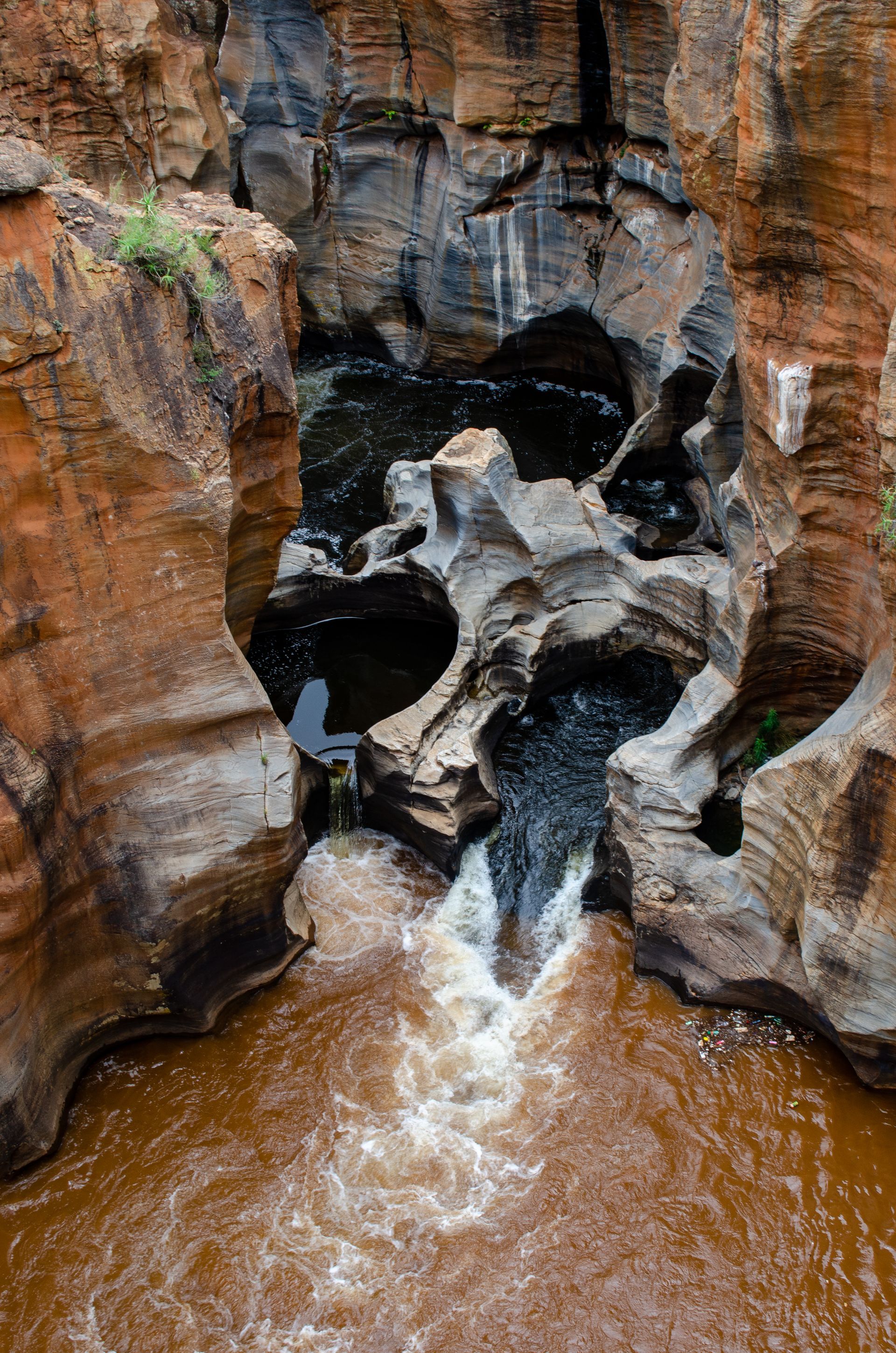 There is a waterfall in the middle of a canyon.