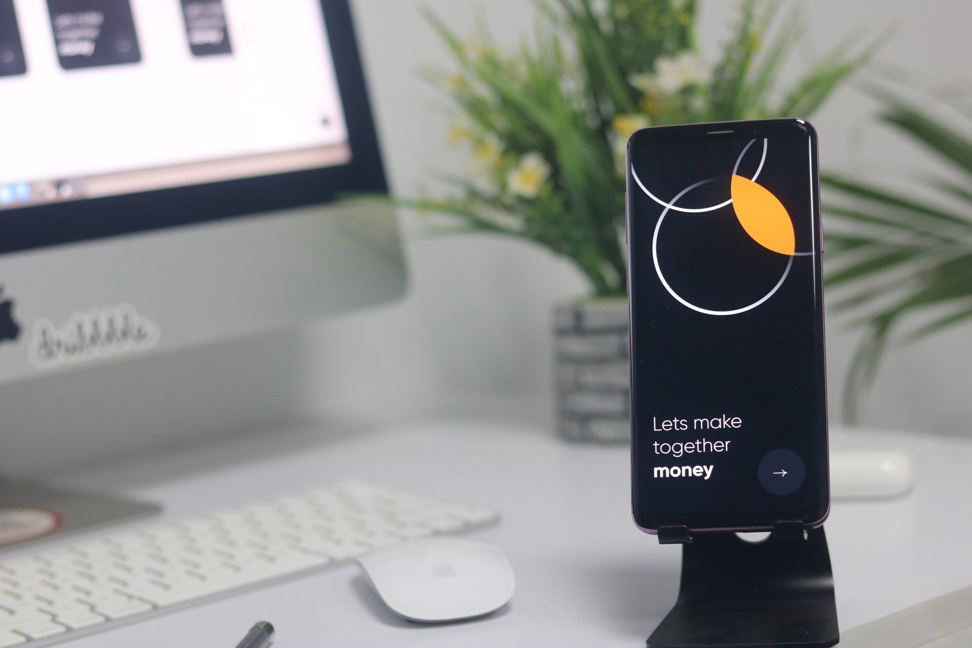 A phone on a stand says let 's make together and why