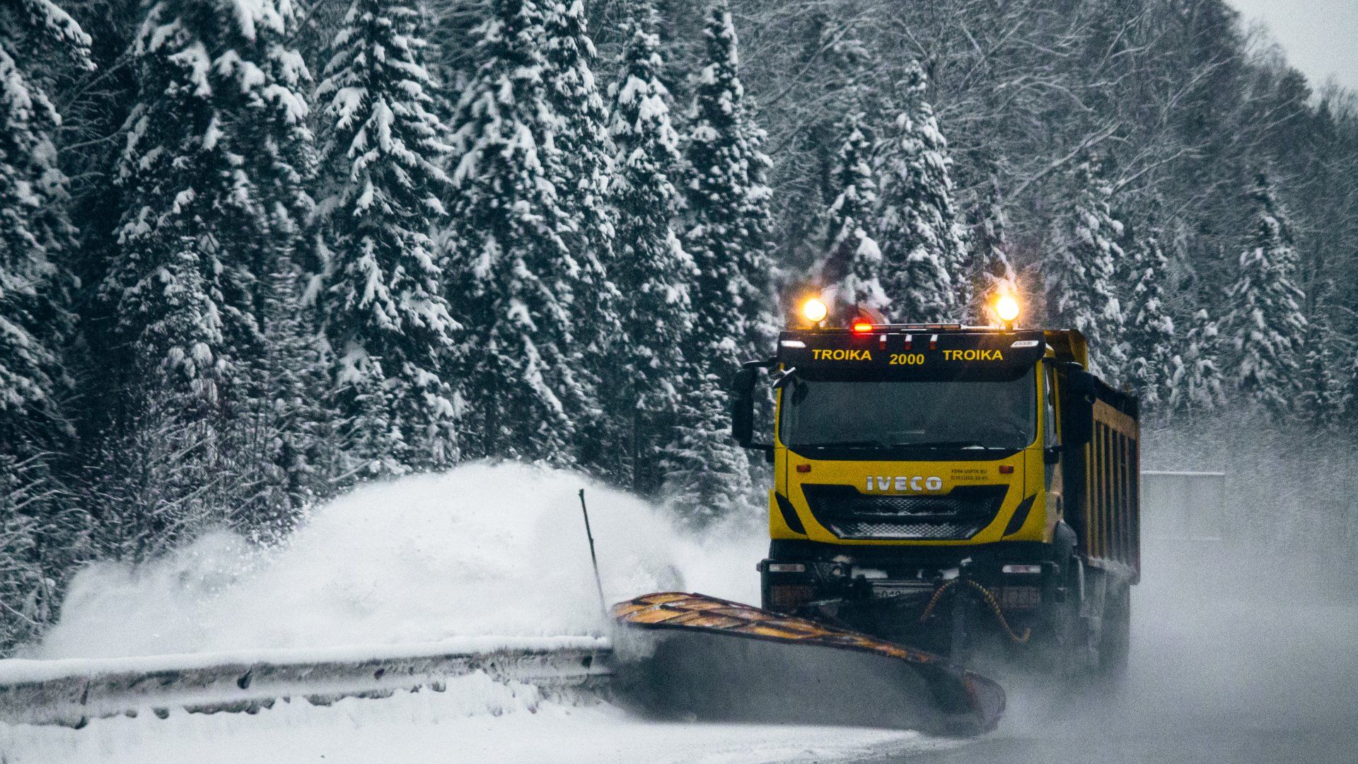 snow plower removing snow from the roadside