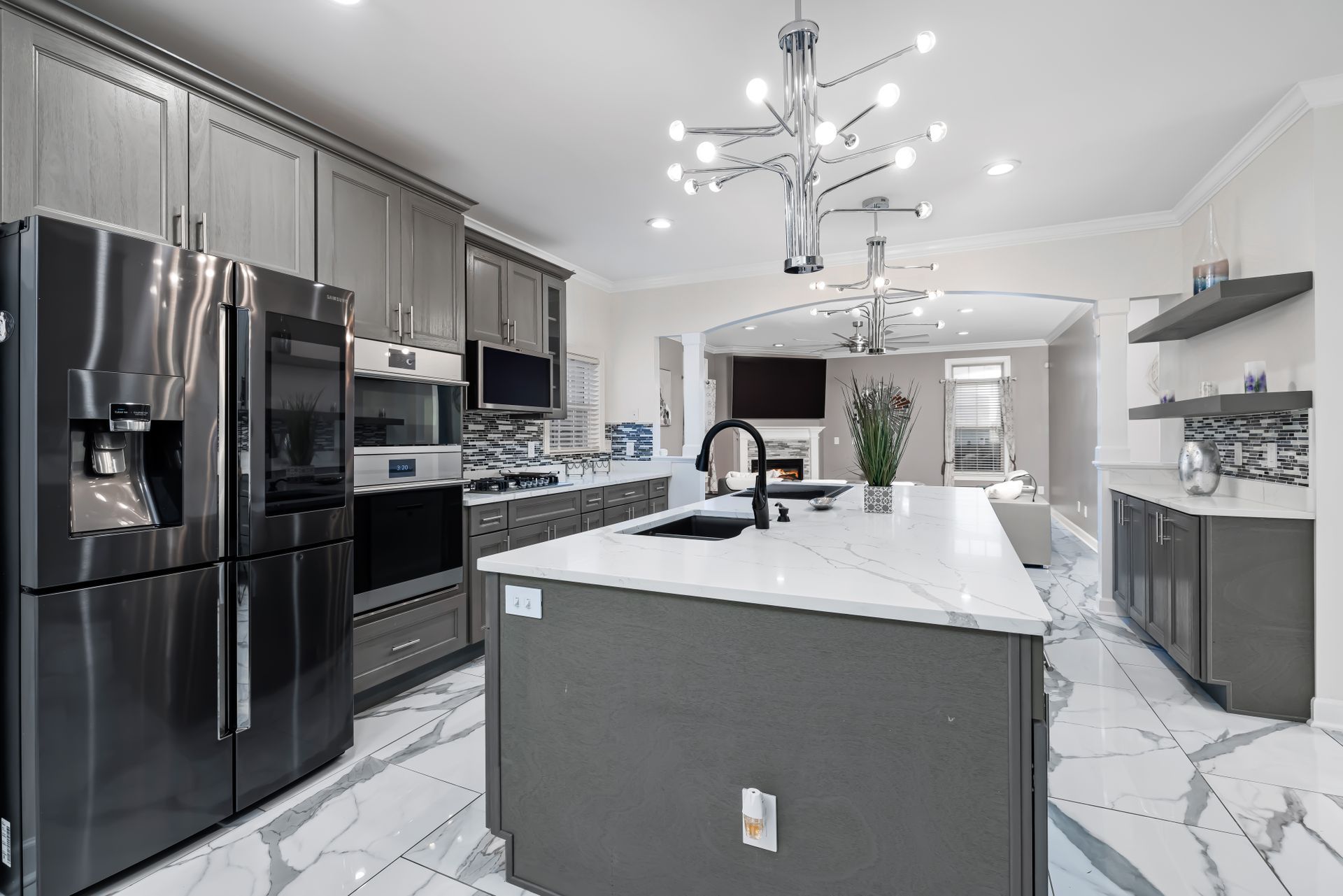 A kitchen with stainless steel appliances and a large island.
