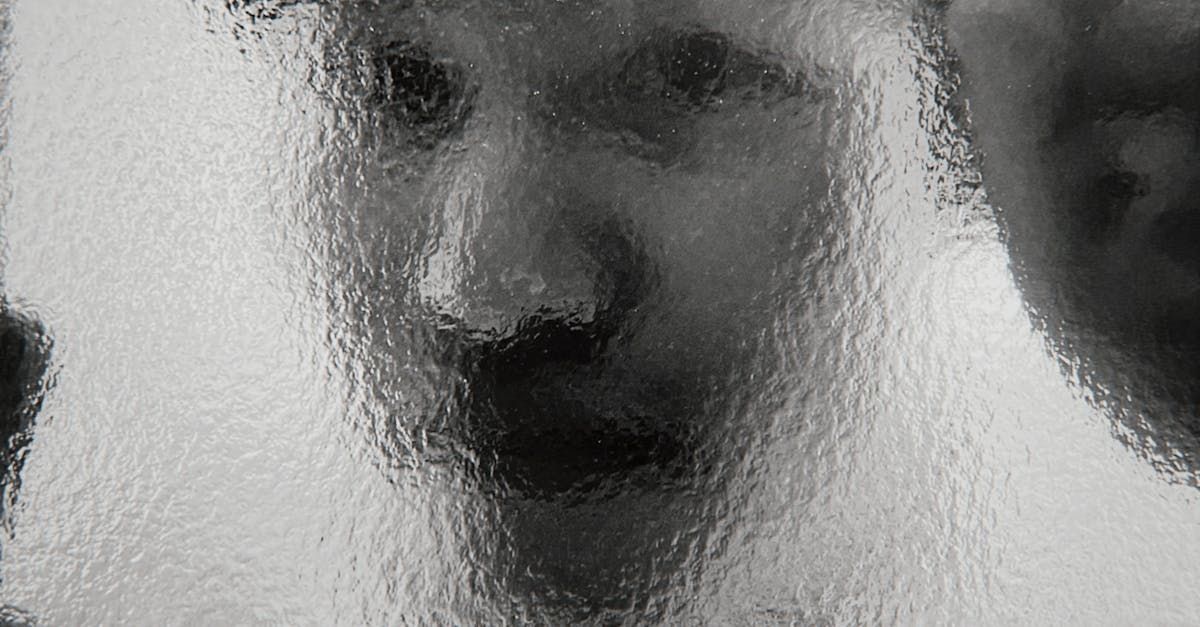 A person peering through a frosted glass panel, symbolizing the opacity of HOA operations. - Empower HOA Web and Software Solutions