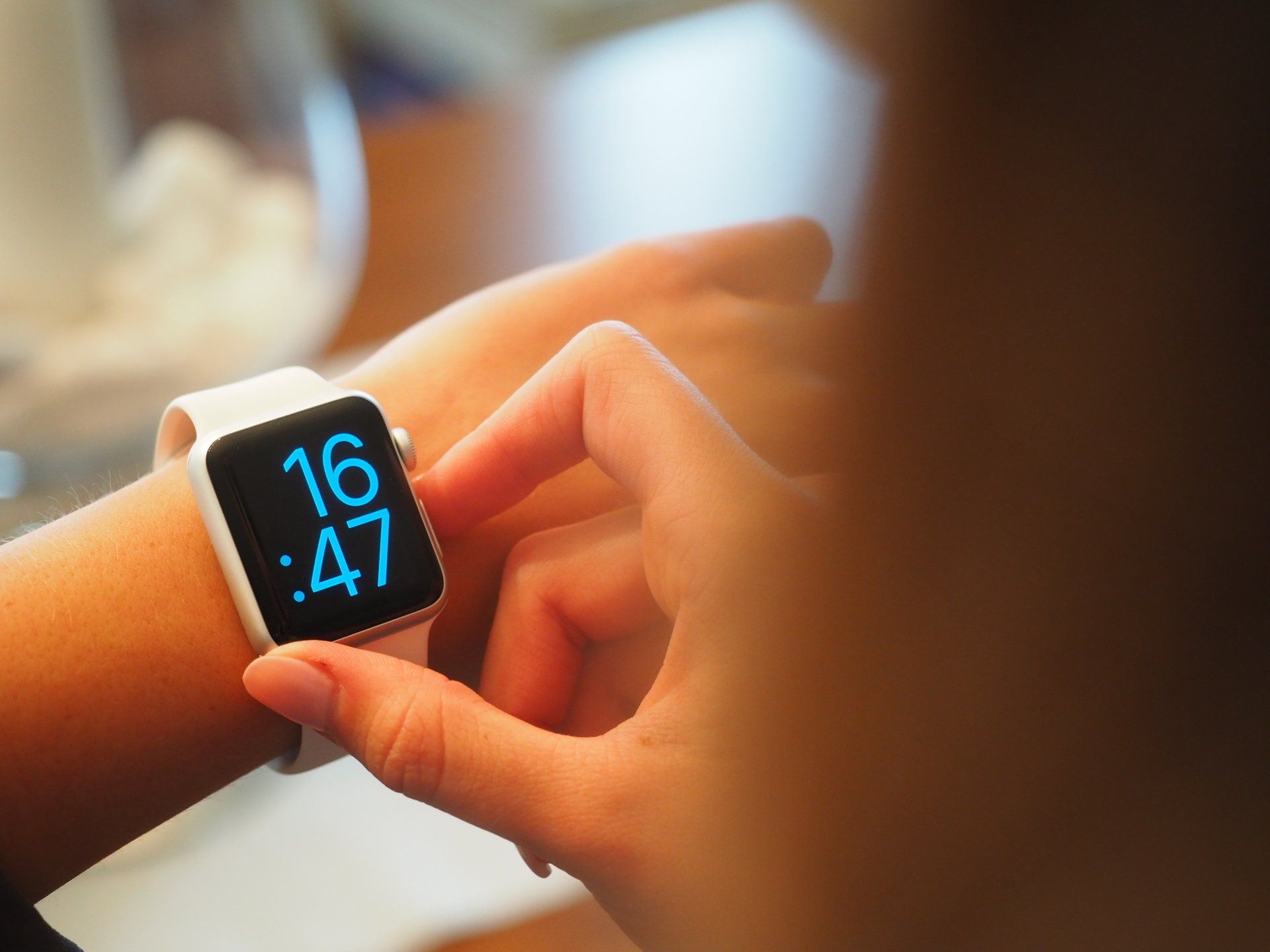 A person checking the time on their Apple Watch