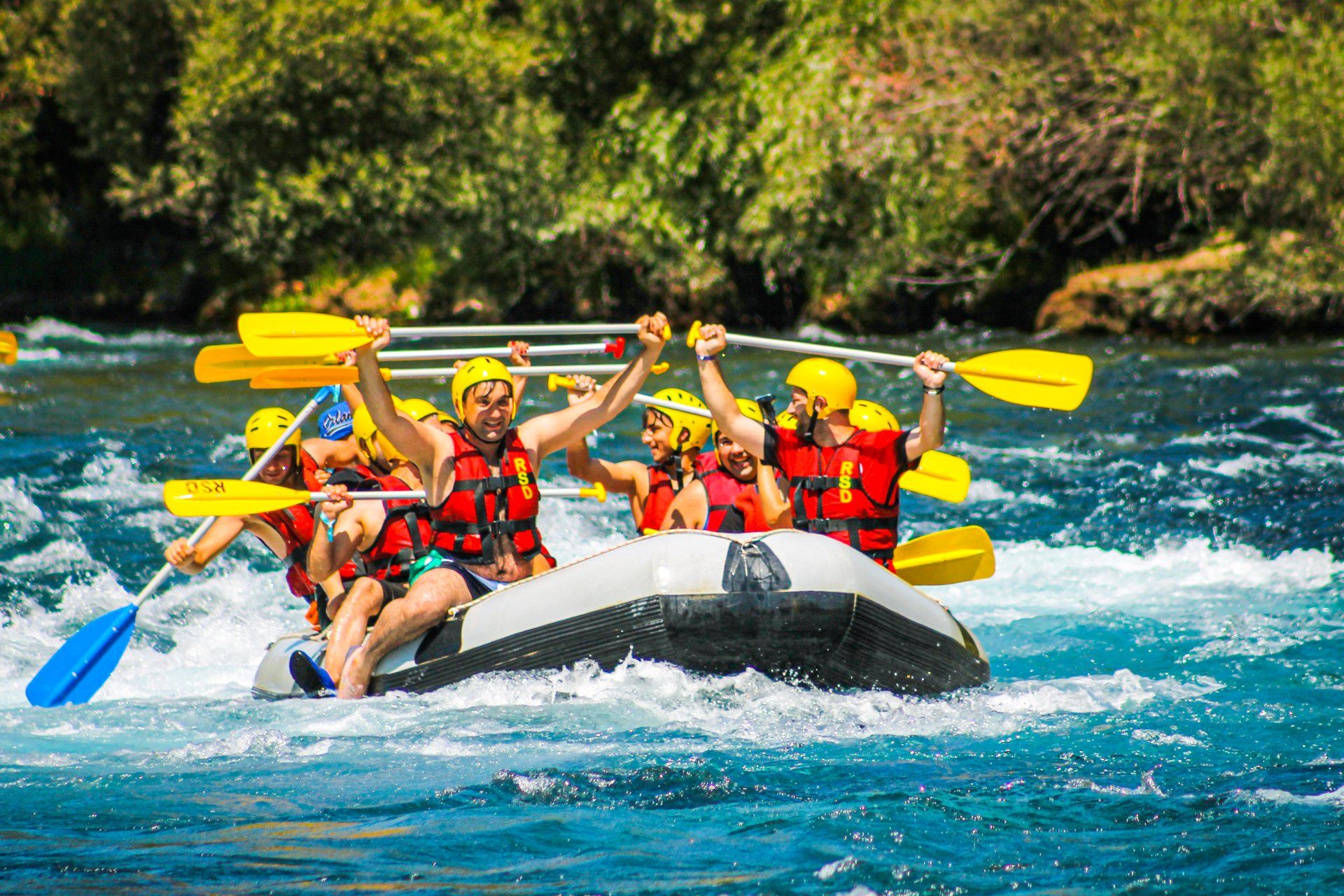 A group of people are rafting down a river in a raft.
