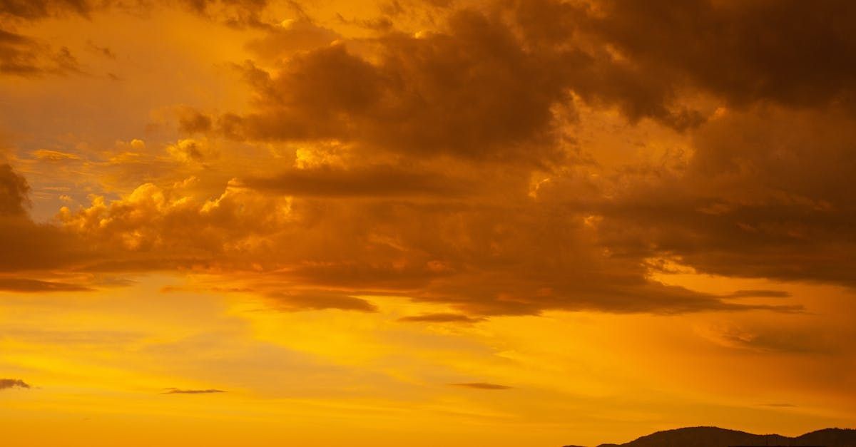 A plane is flying in the sky at sunset.