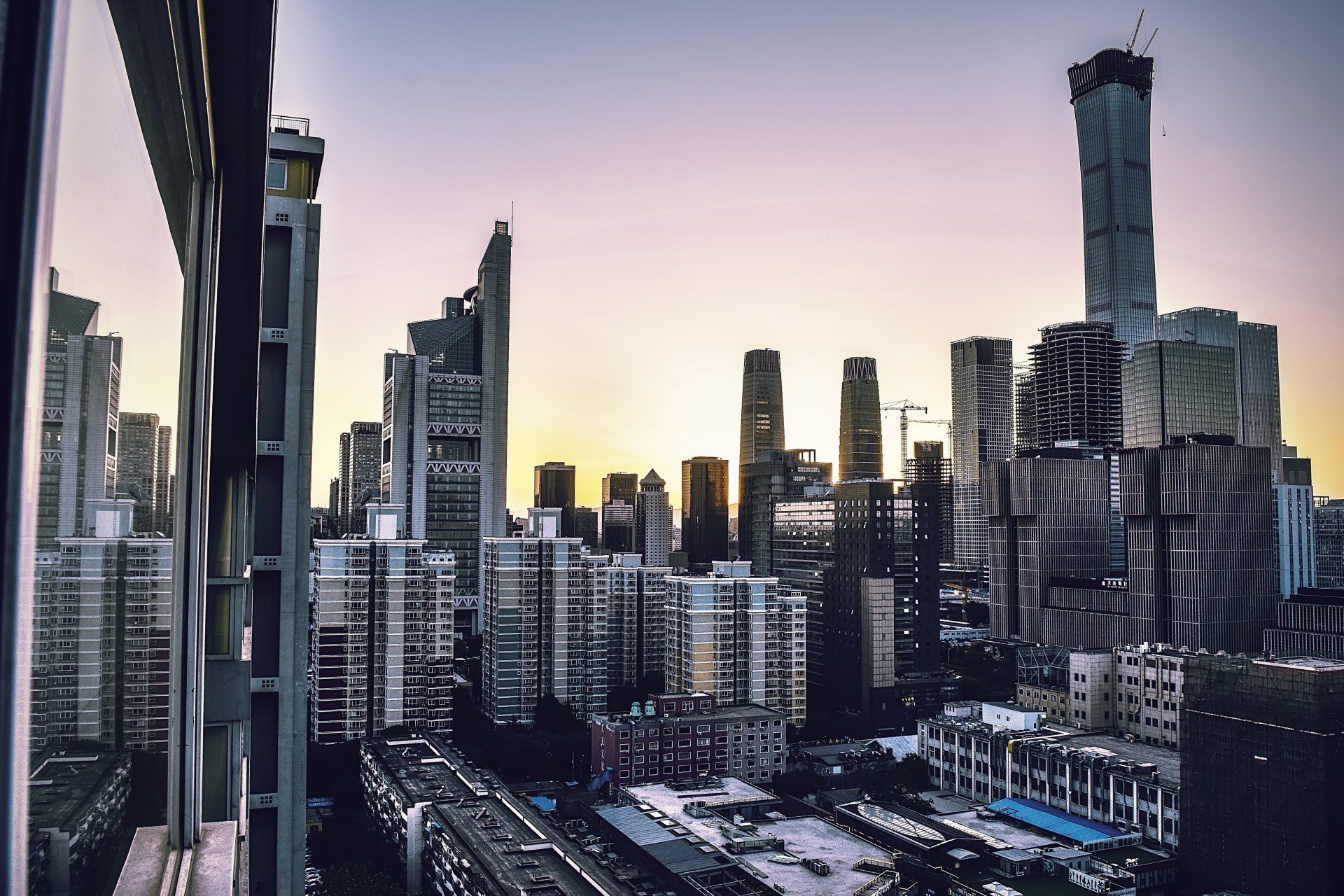 An aerial view of a city skyline at sunset