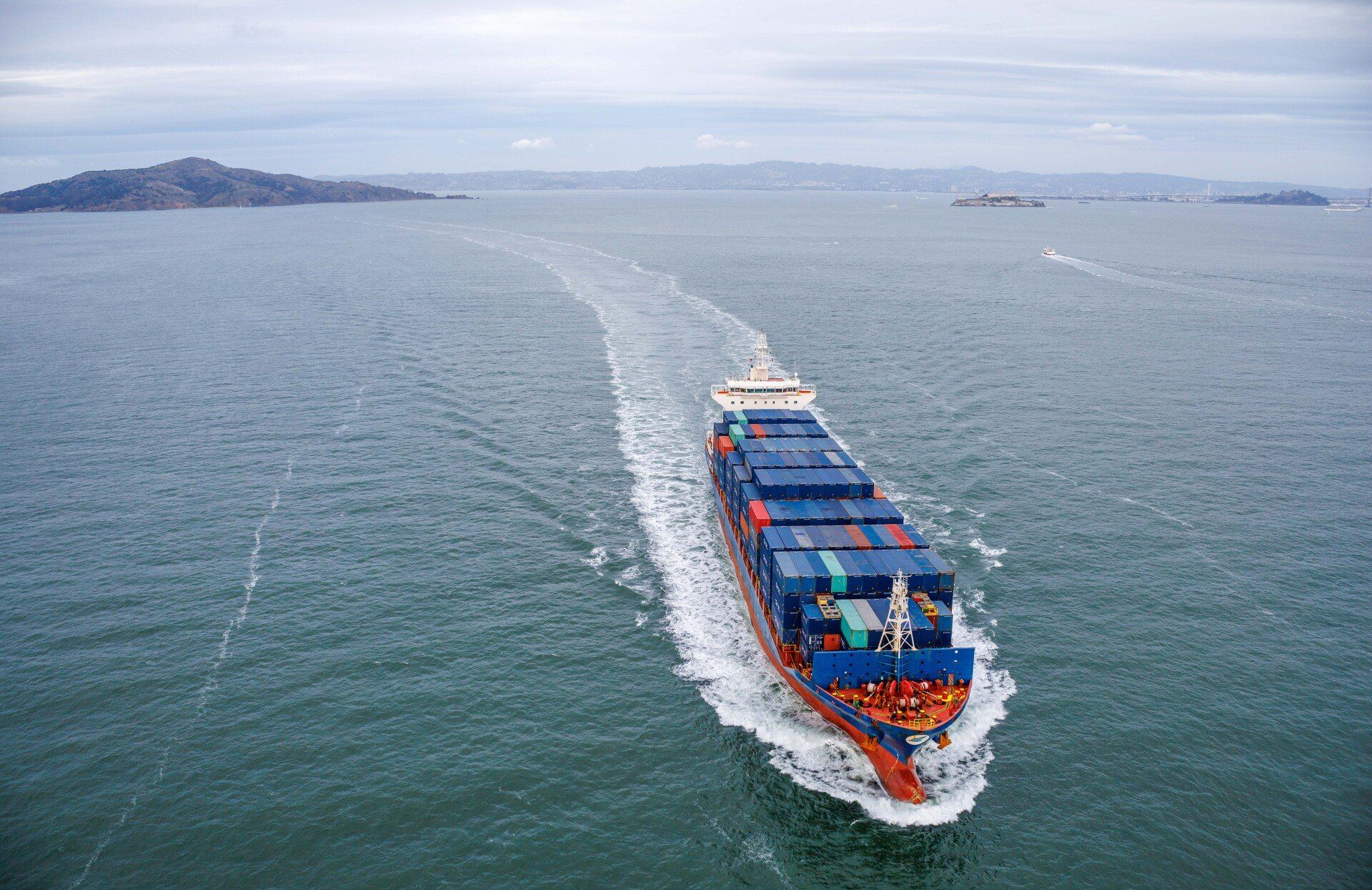An aerial view of a large container ship floating on top of a body of water.