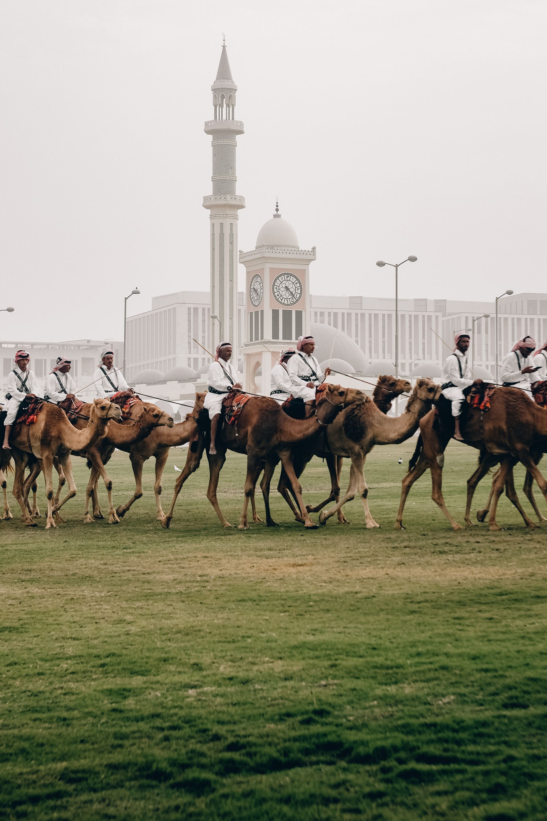 Camel-mounted royal guards patrol around the Amiri Diwan in Doha, Qatar.