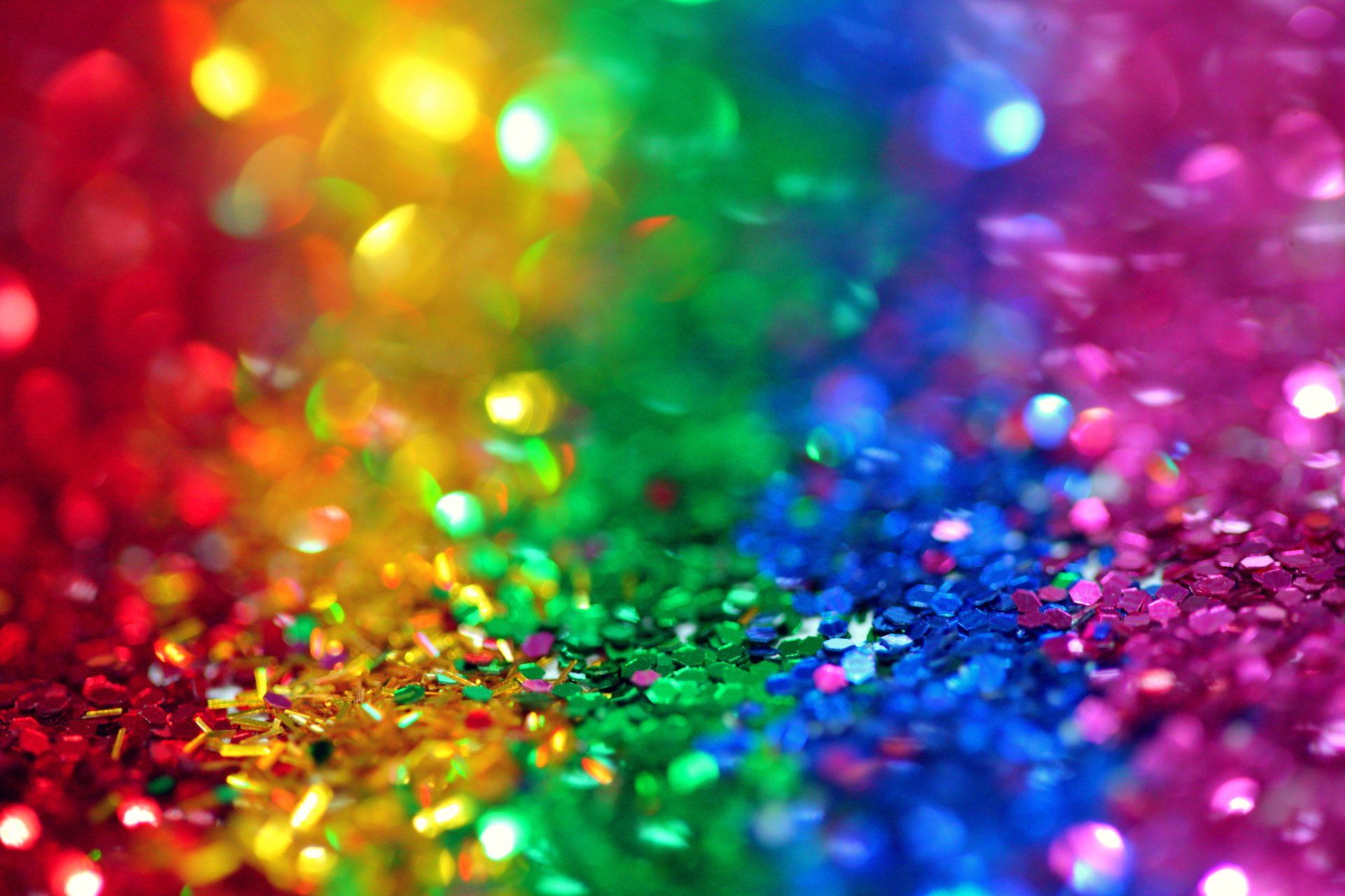 Eine Nahaufnahme eines regenbogenfarbenen Glitzerhintergrunds