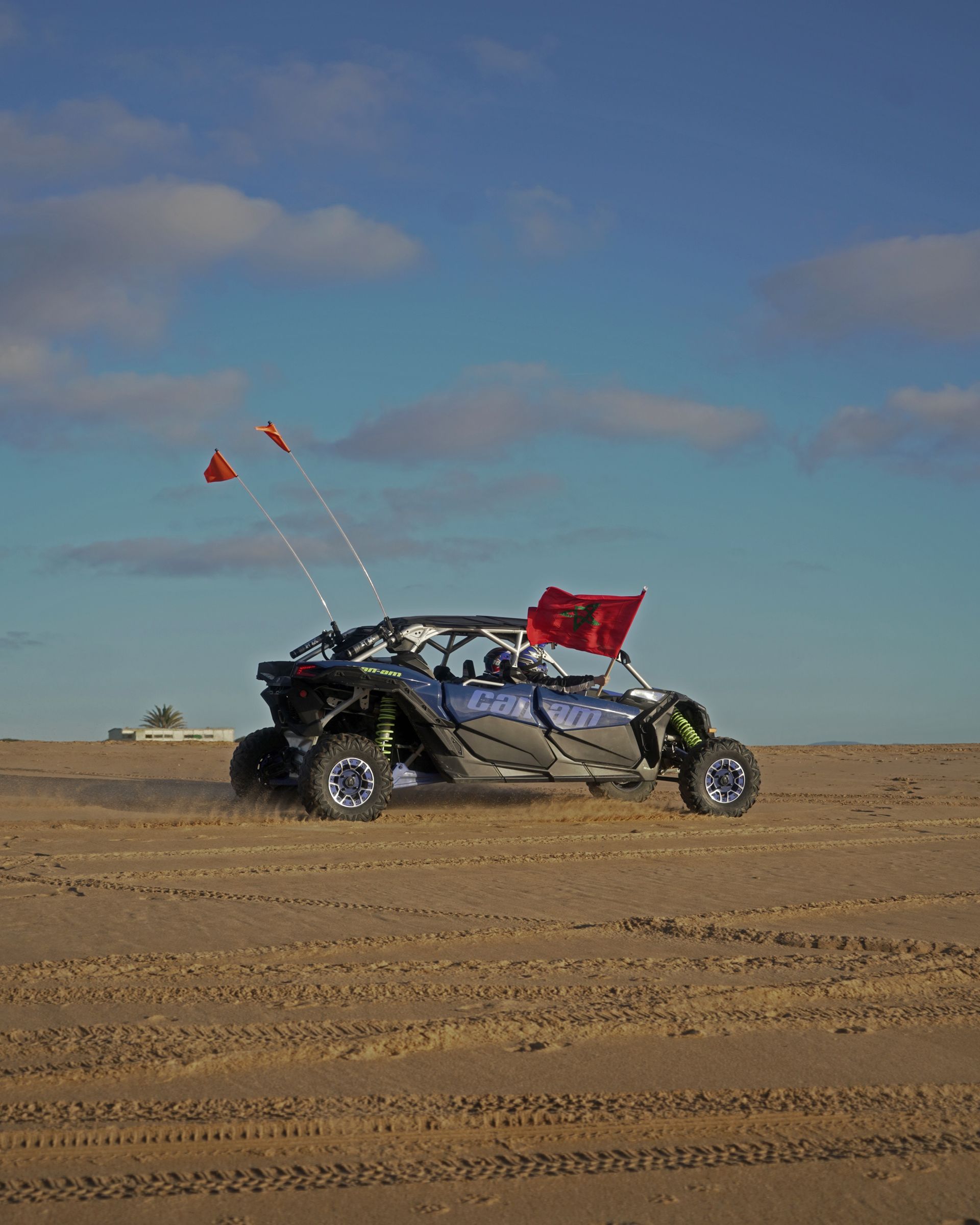 A person is riding a atv in the desert.