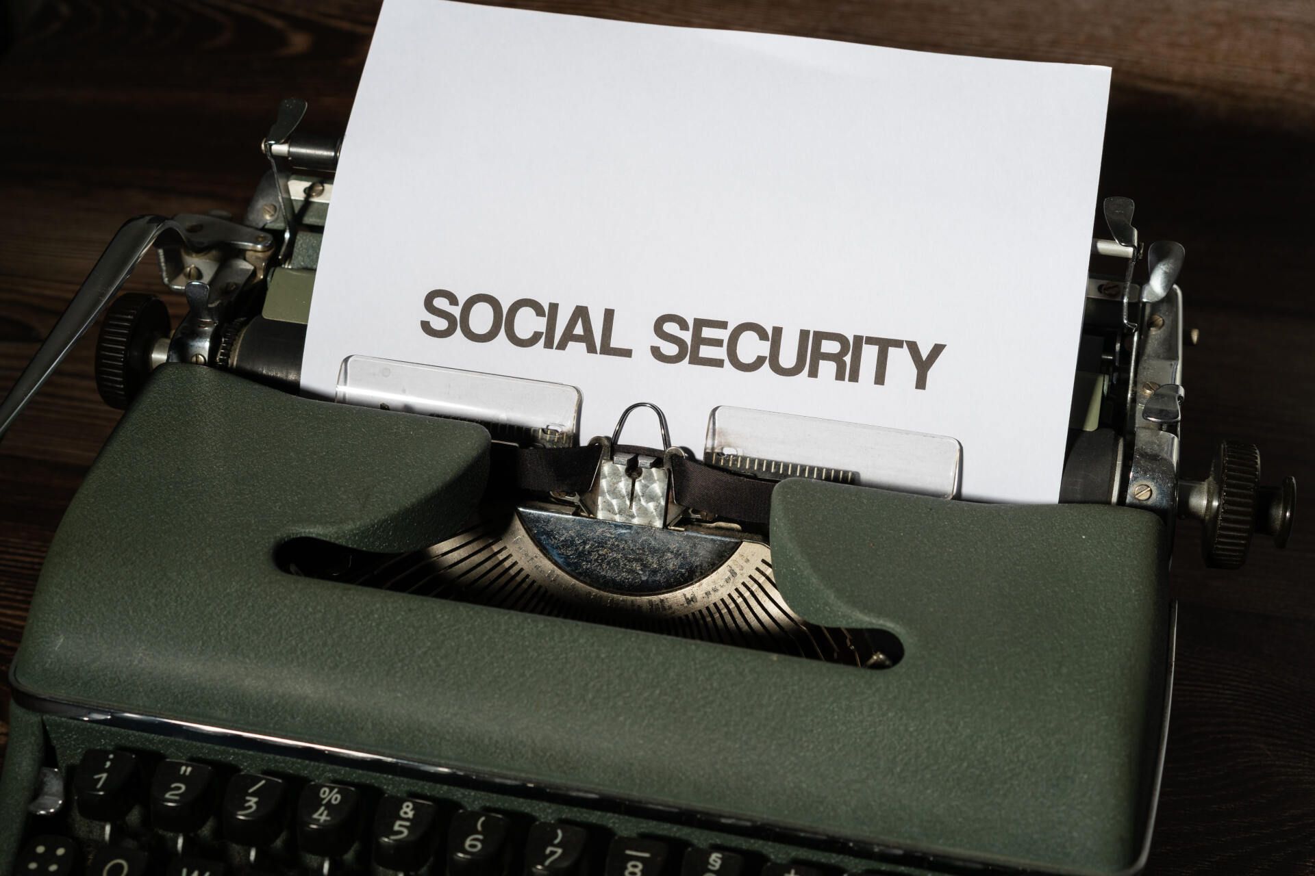 A typewriter with a piece of paper that says social security on it