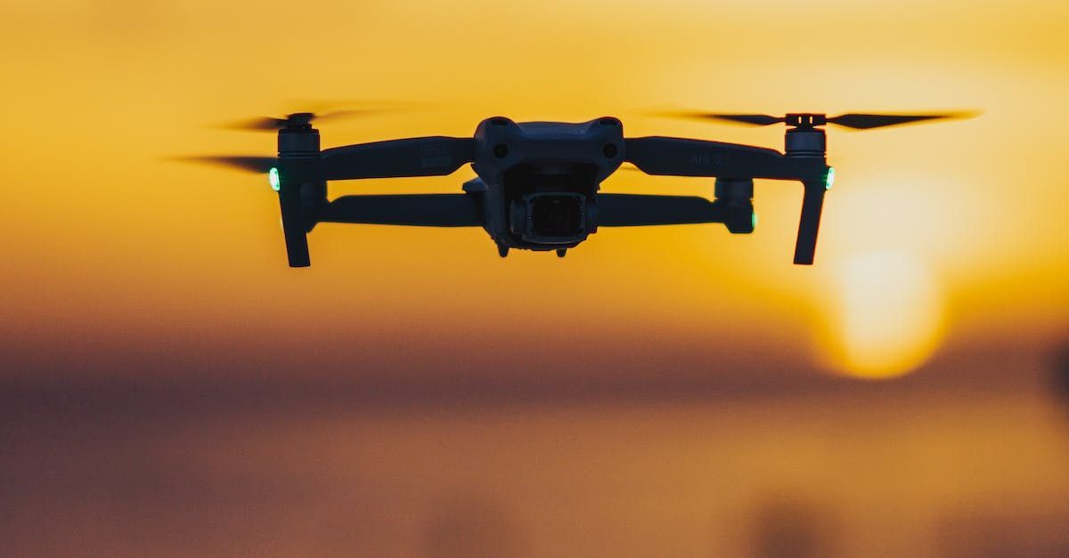 Drone in Flight: An aerial view capturing a drone in mid-flight. The image shows the drone hovering or moving through the air, possibly capturing photos or video.