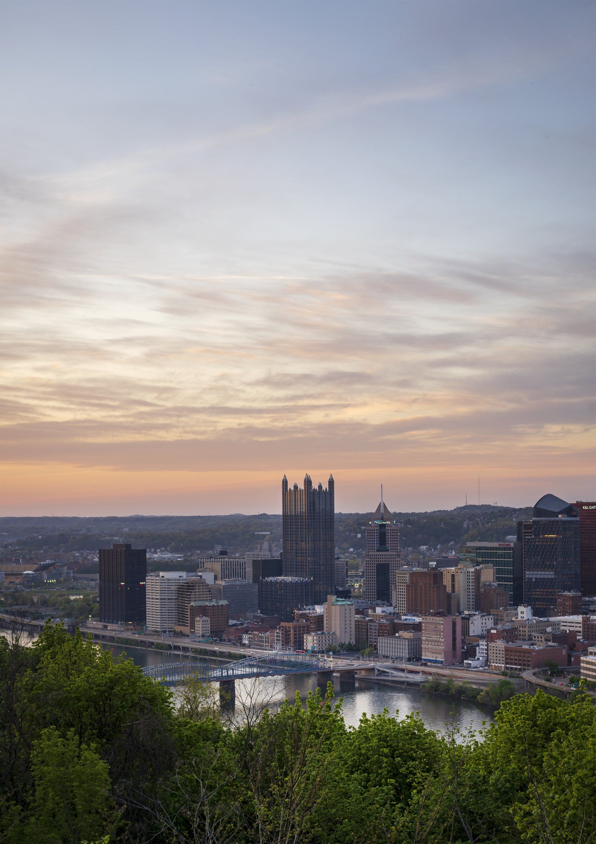 An aerial view of a city at sunset with a river in the foreground.
