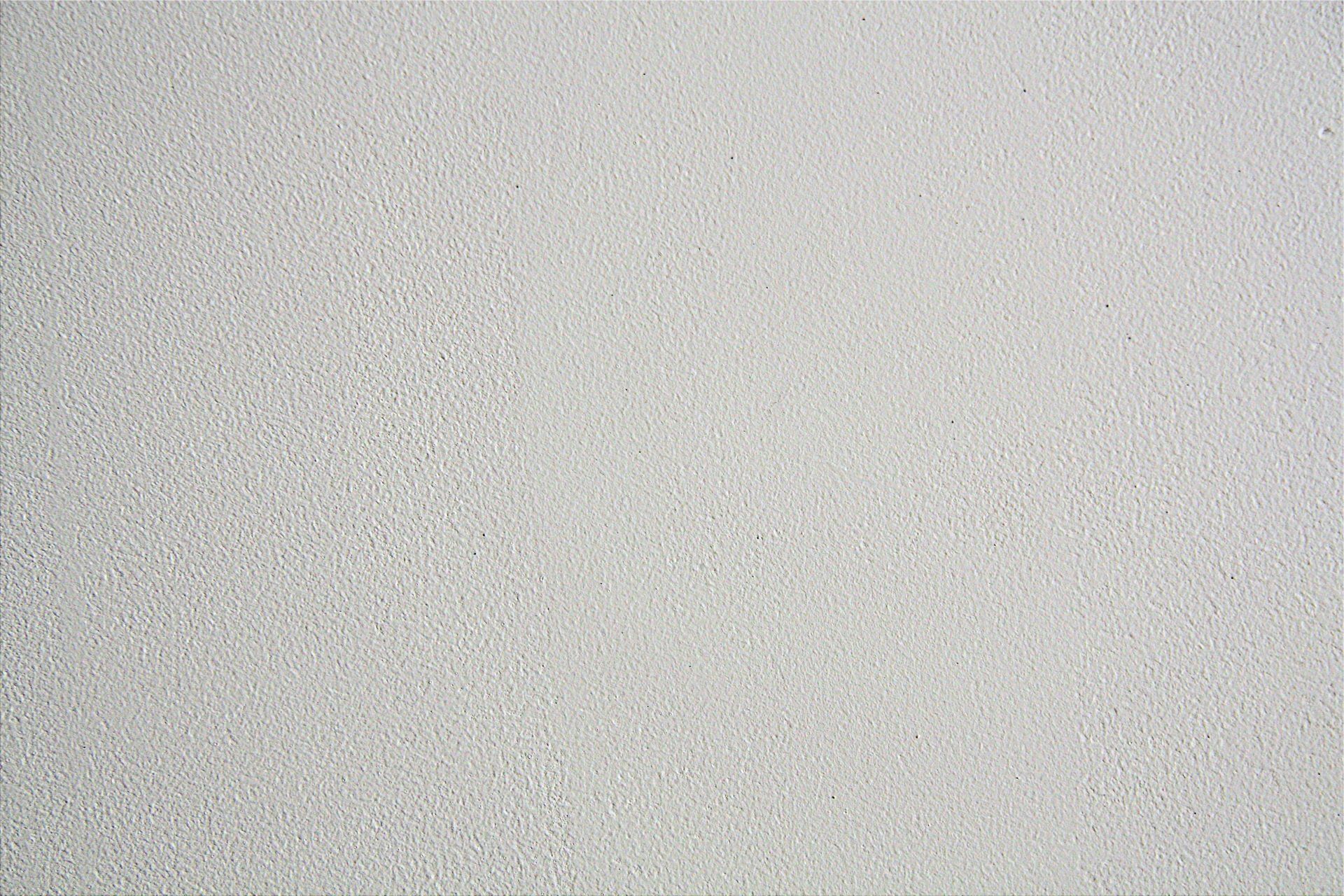 Close-up of a light gray, textured surface with subtle speckling