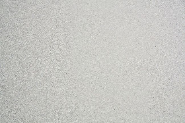 A close up of a white surface with a grainy texture.
