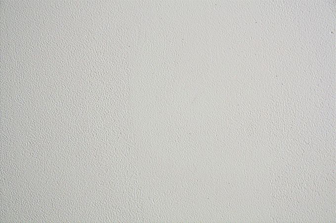 Textured white surface with small bumps.