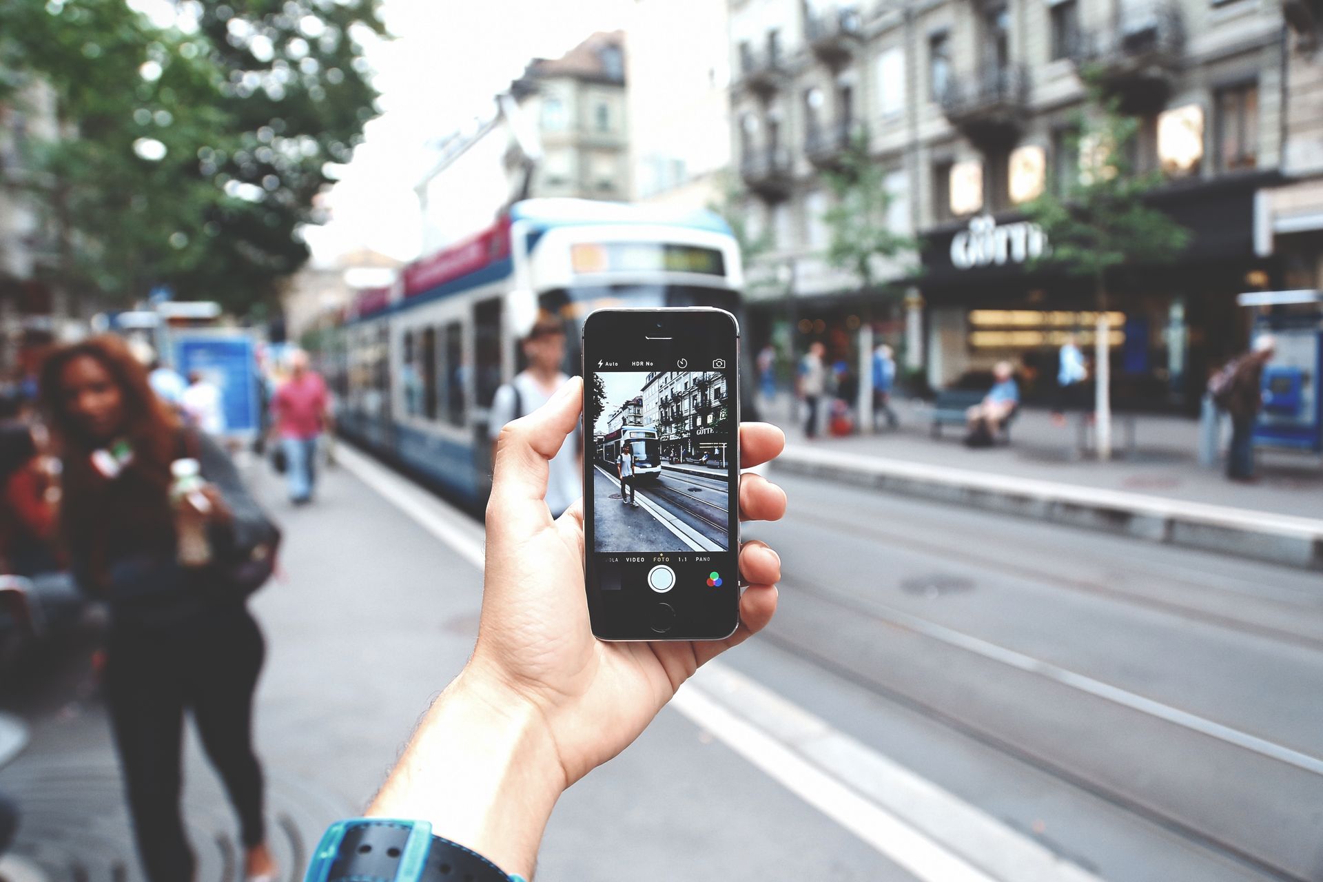 A person is taking a picture of a street with a cell phone.