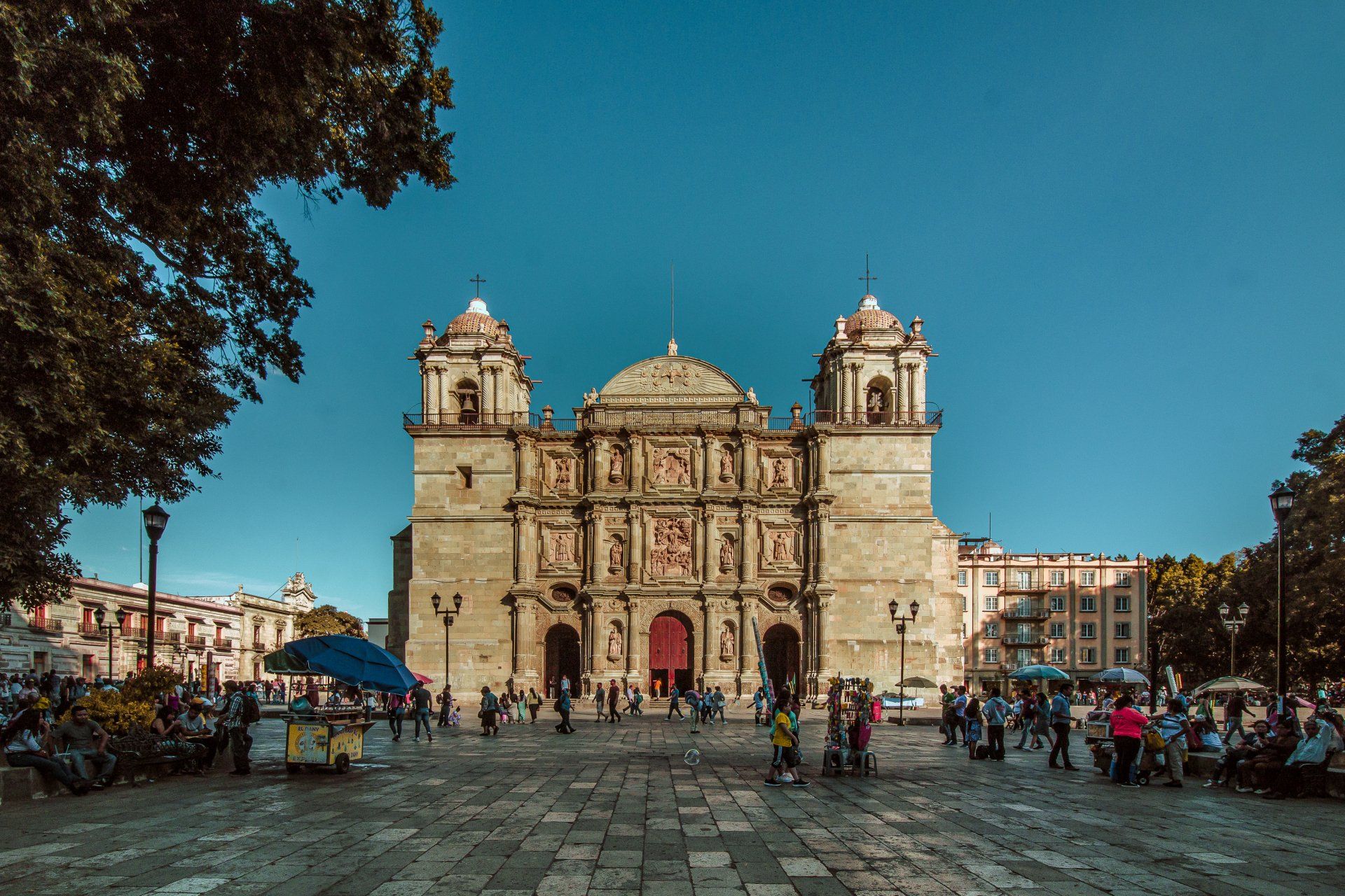 A large building with a lot of people standing in front of it.