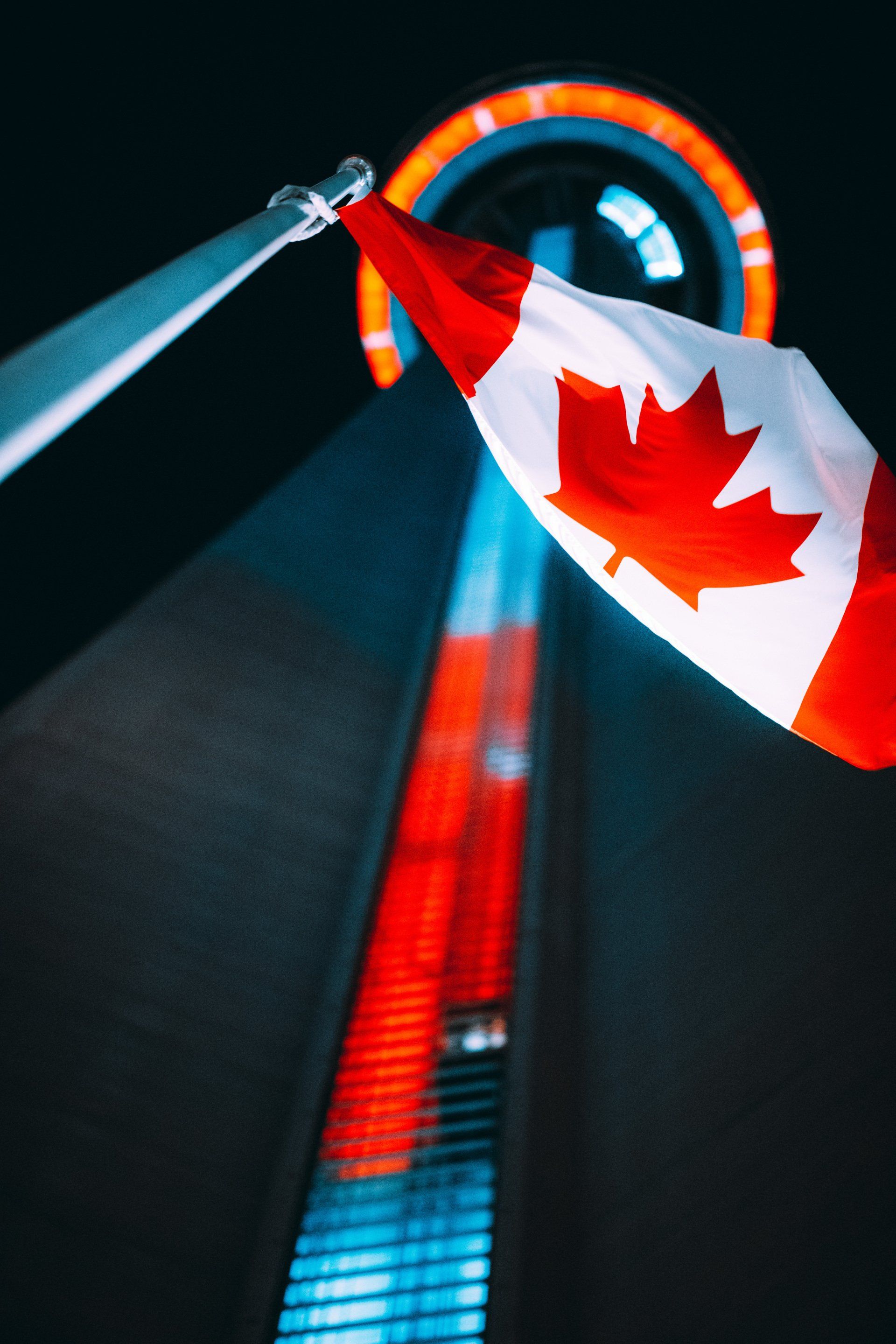 Canadian flag flying above an image of the CN Tower