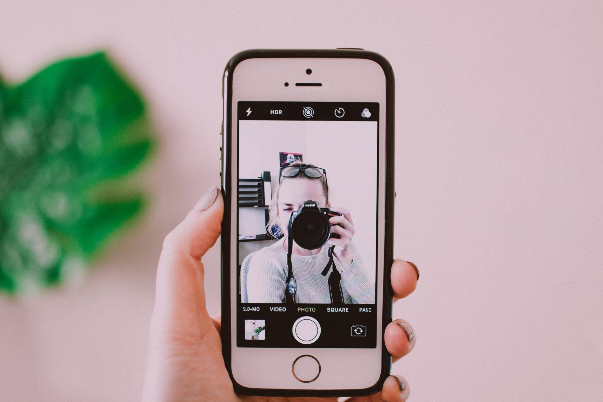 A person is taking a picture of themselves with a camera on their phone.