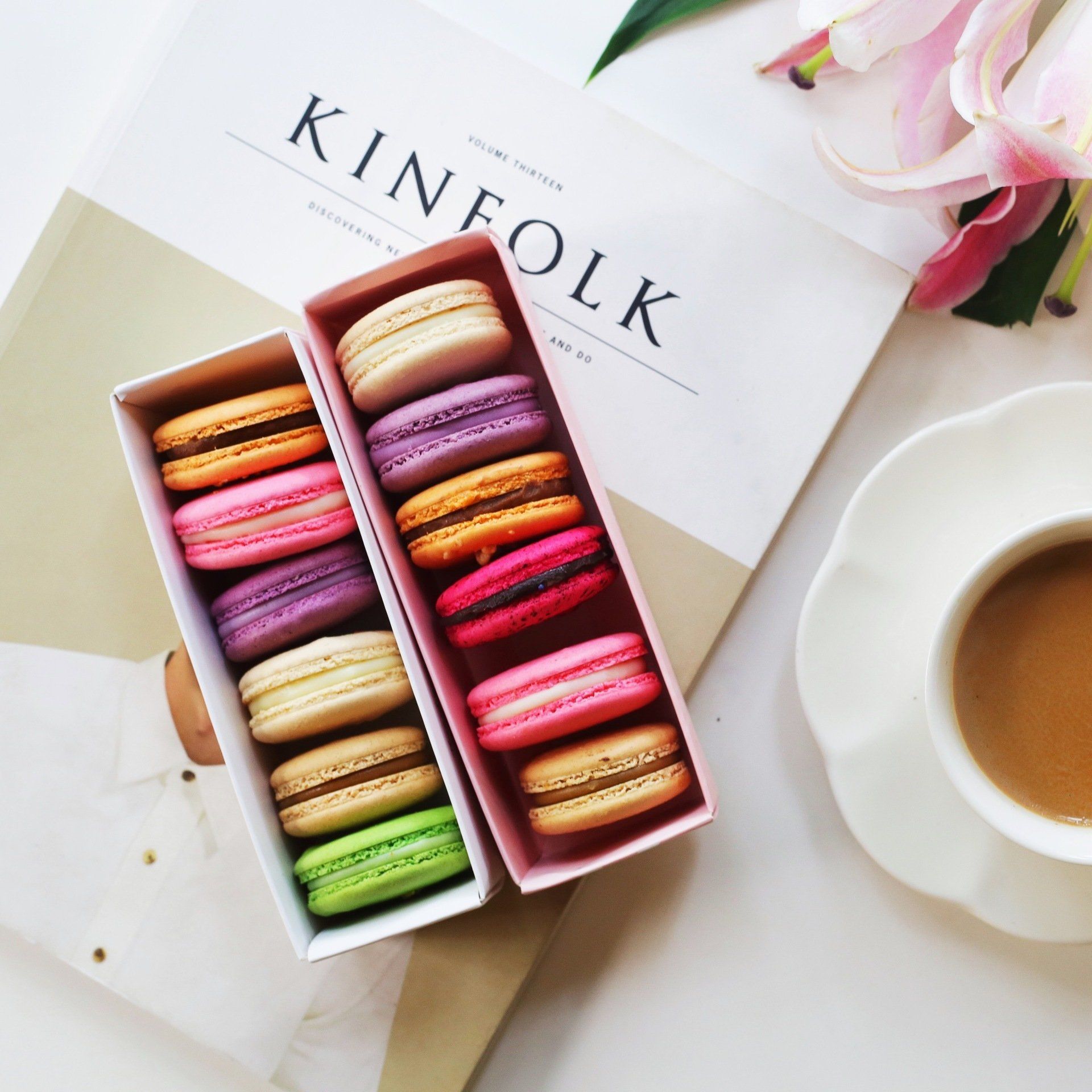Three boxes of macarons next to a kinfolk magazine