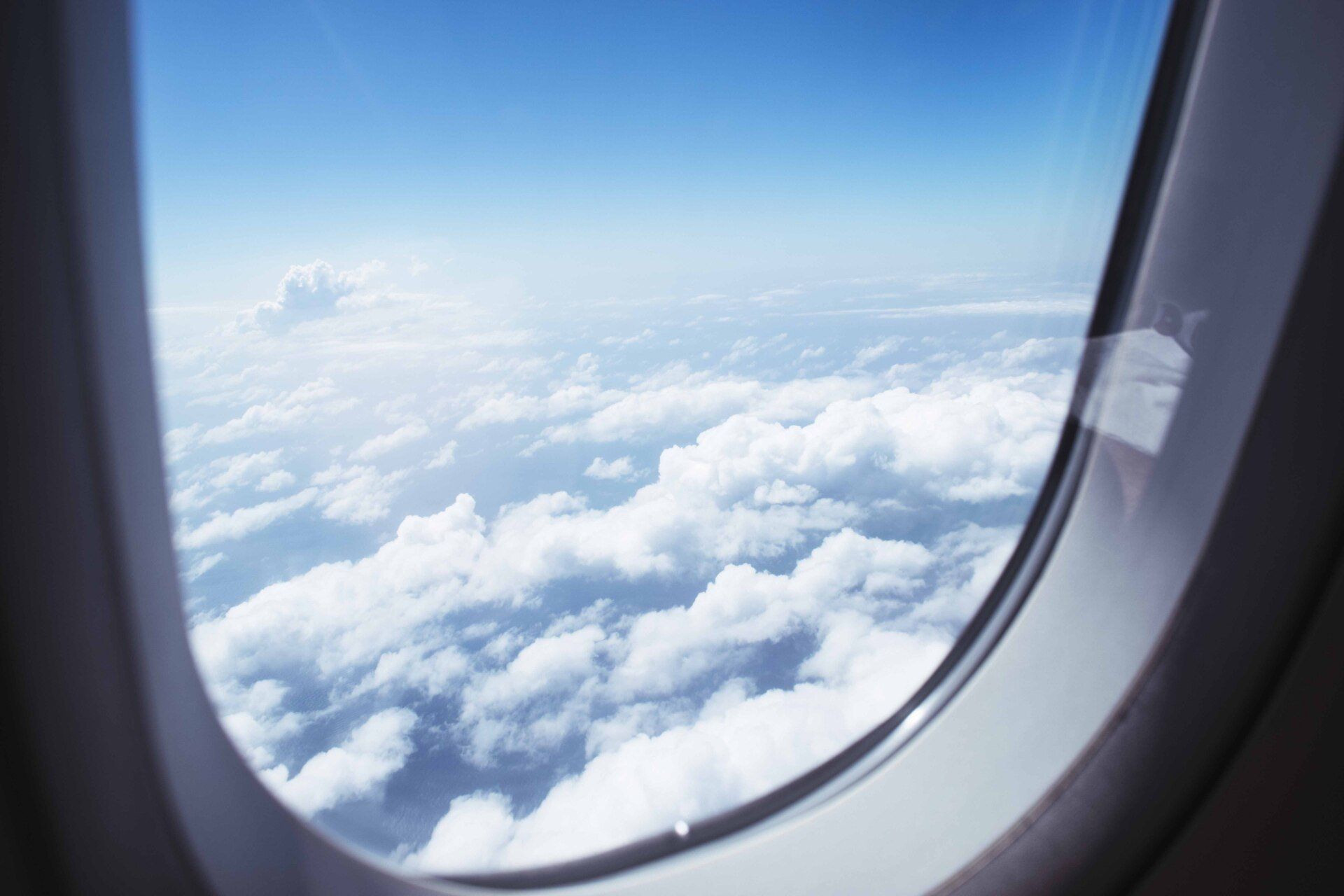 a view of the clouds from an airplane window .