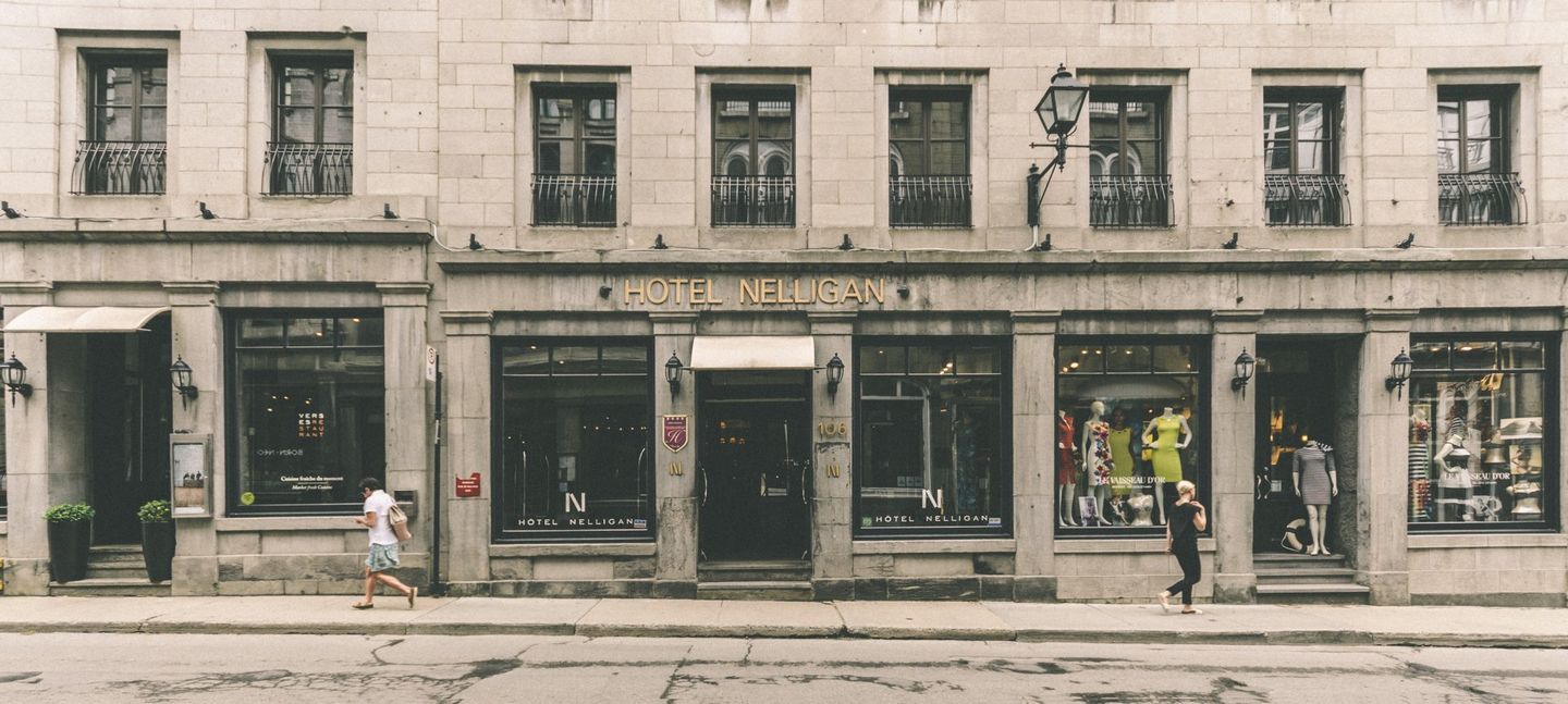 A row of stores are lined up on a city street of Montreal