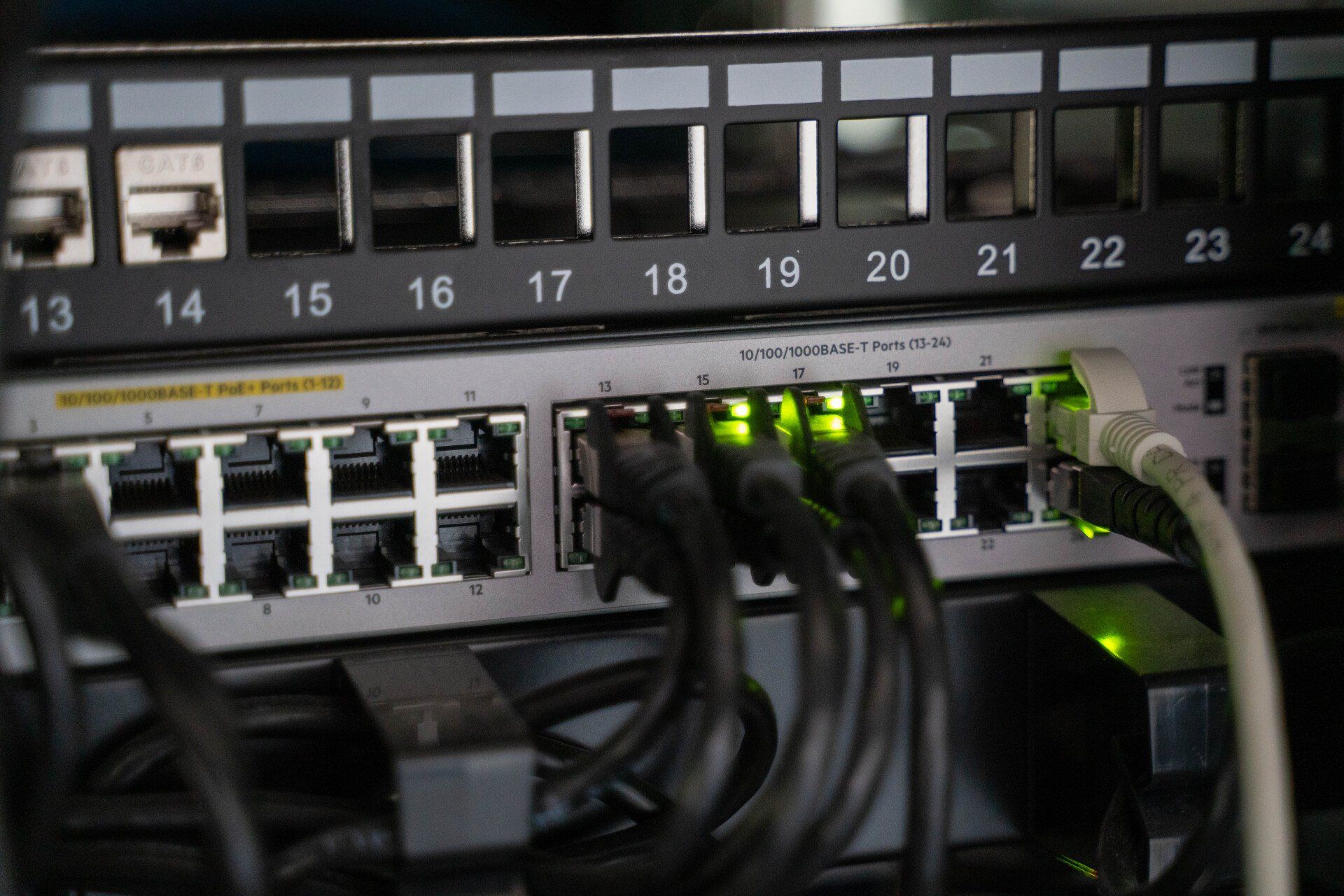 Business network switch with connected Ethernet cables used for managed network setup and IT infrastructure support