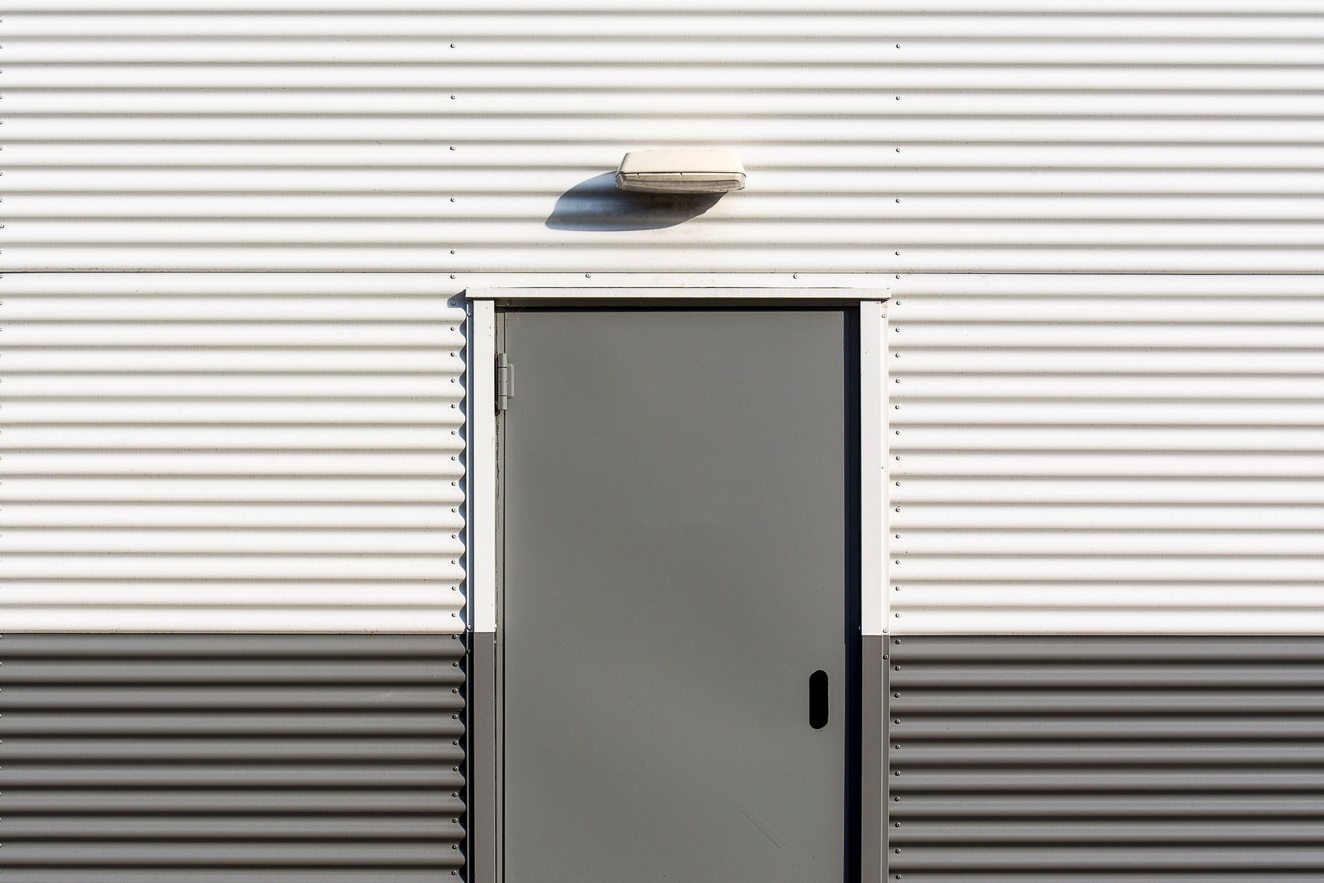 There is a door on the side of a building.