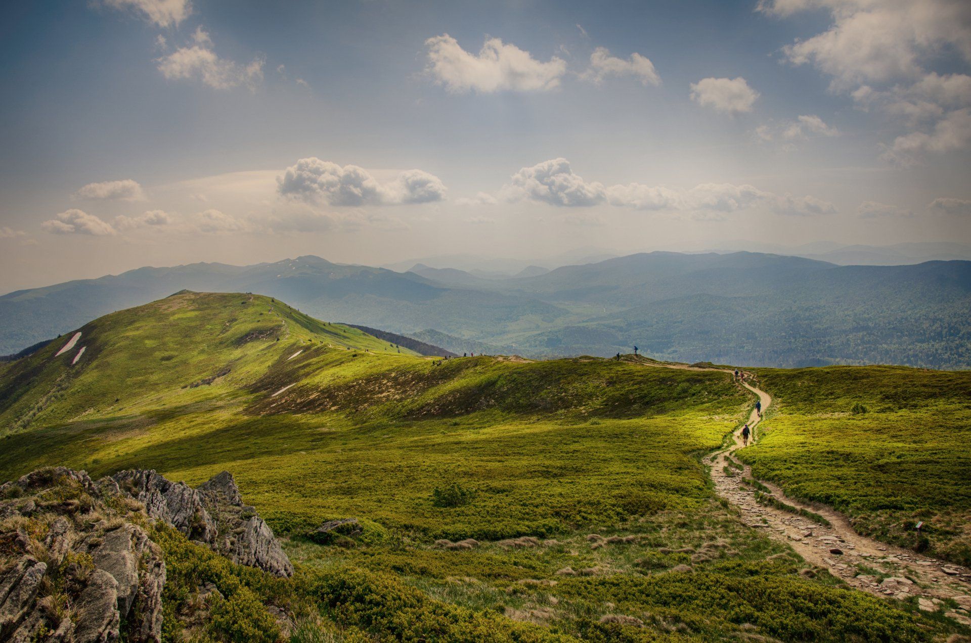 A person is walking on a path in the mountains.