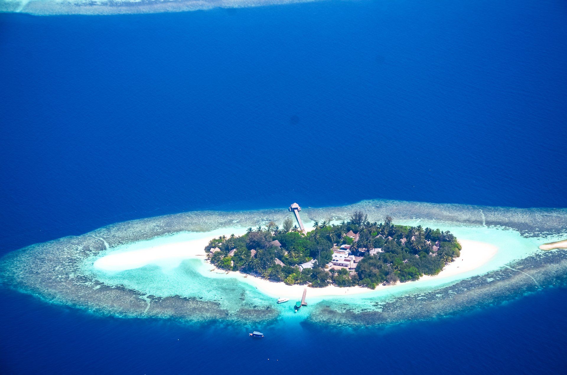 An aerial view of a small island in the middle of the ocean.