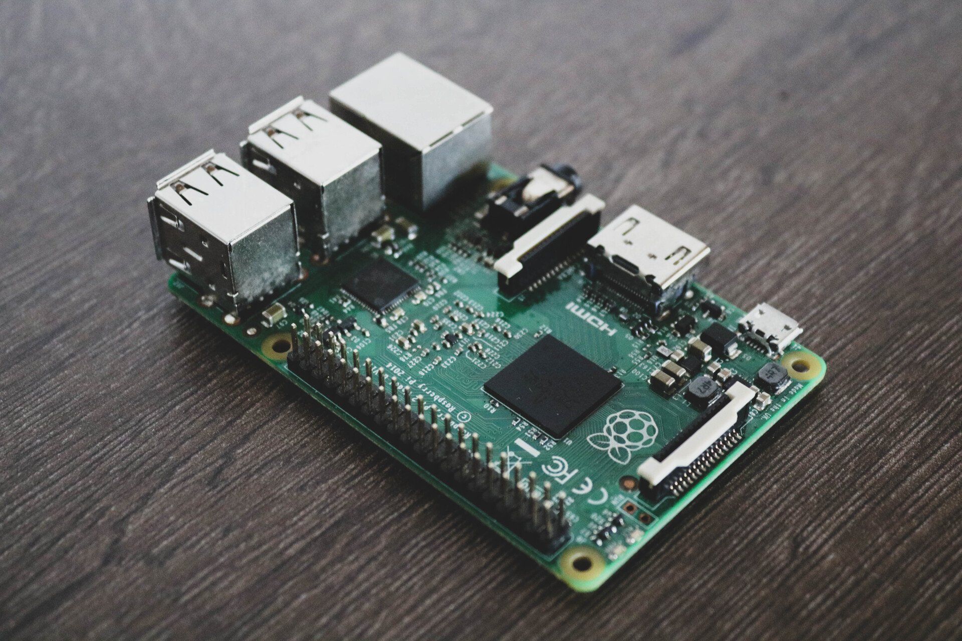 a raspberry pi computer is sitting on a wooden table .