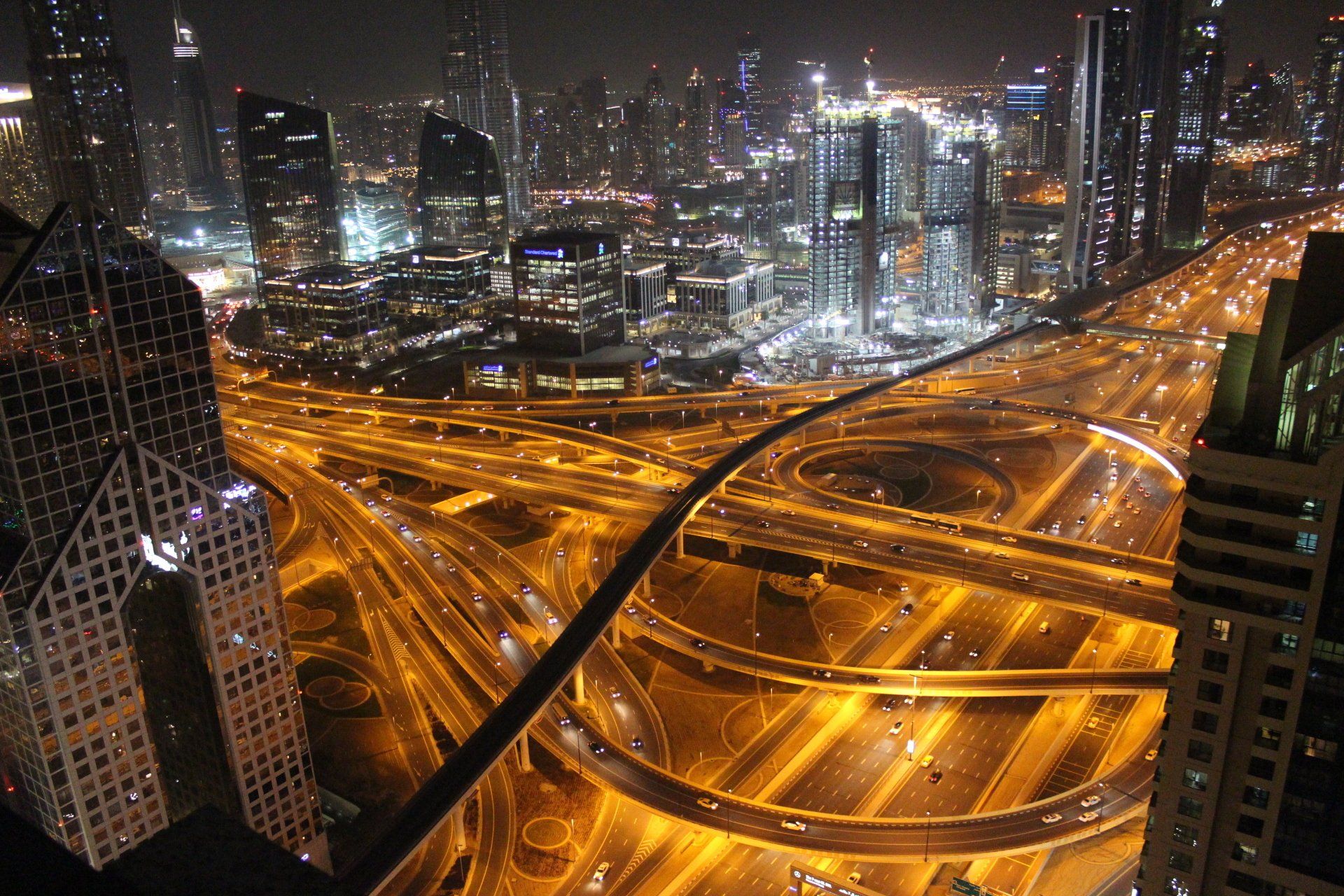 An aerial view of a city at night with lots of traffic