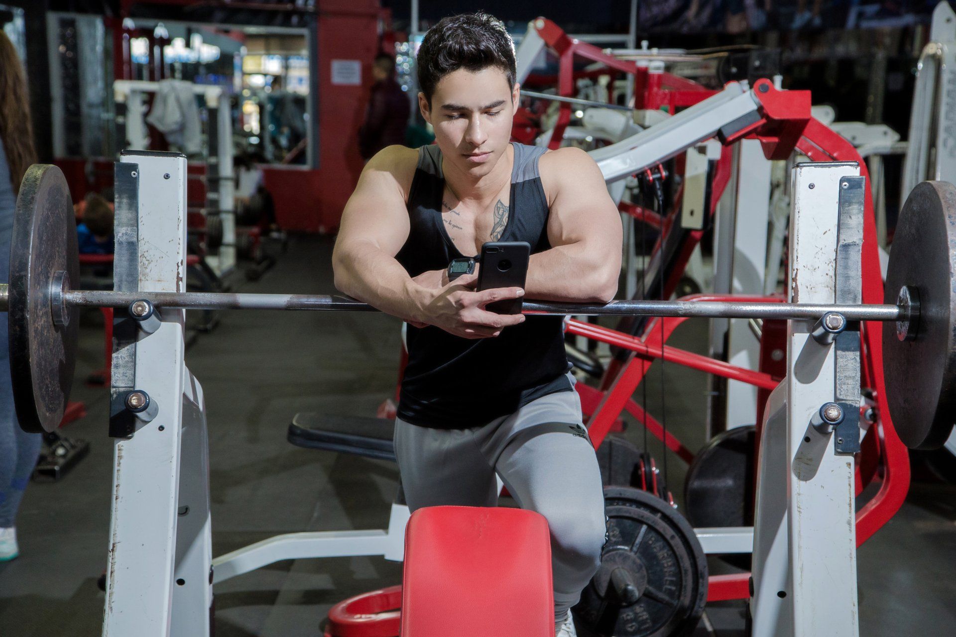 Man at gym distracted by phone