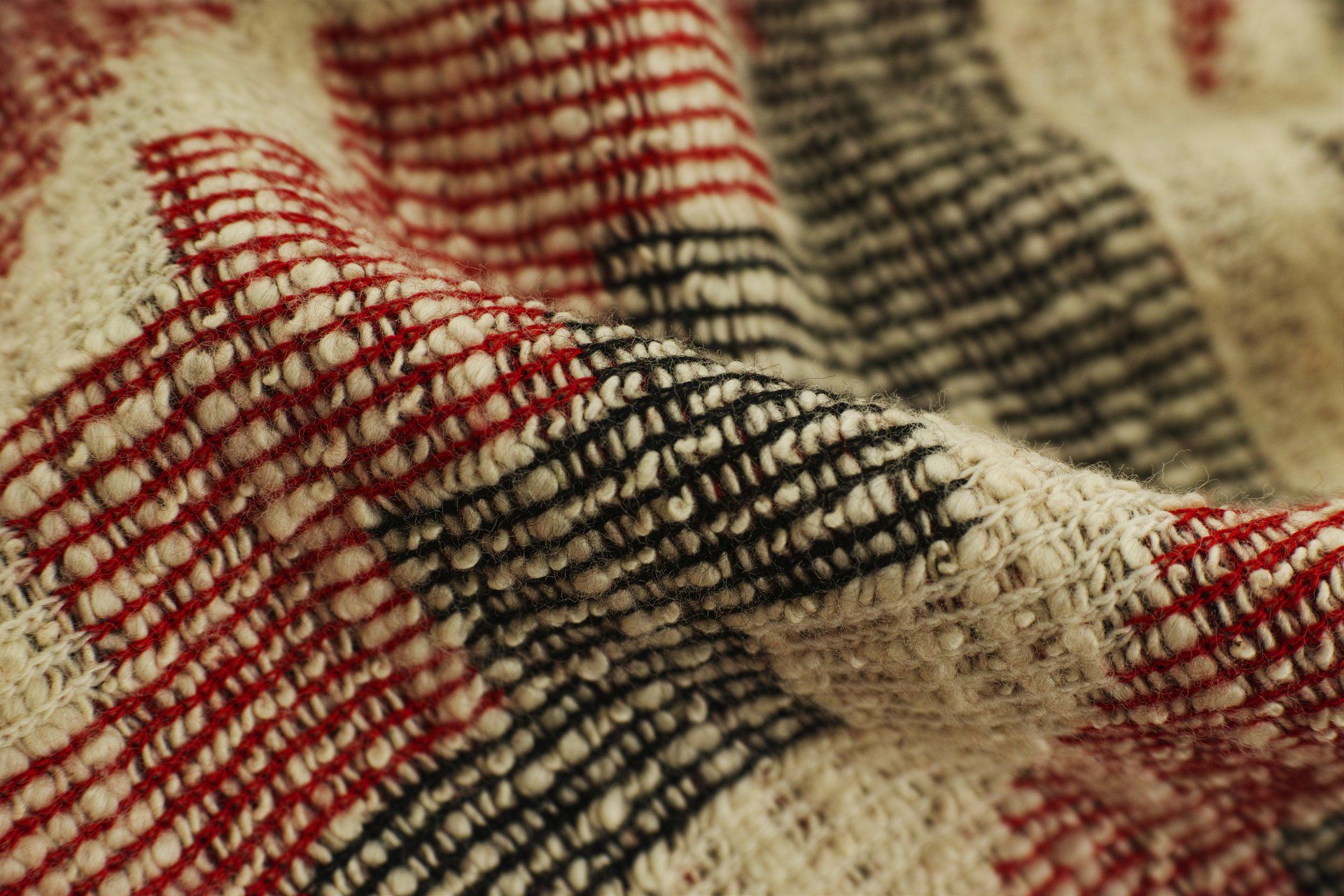 A close up of a red and black plaid blanket.