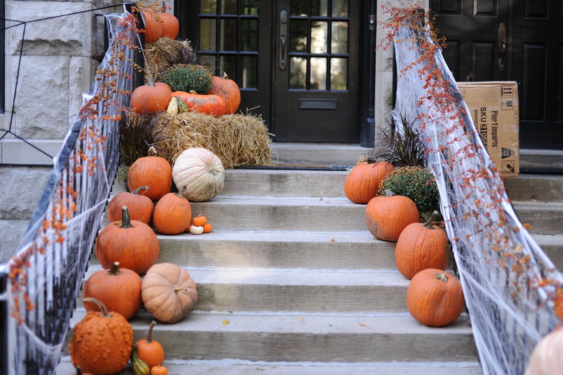Stairs decorated for halloween with pumpkins and hay bales