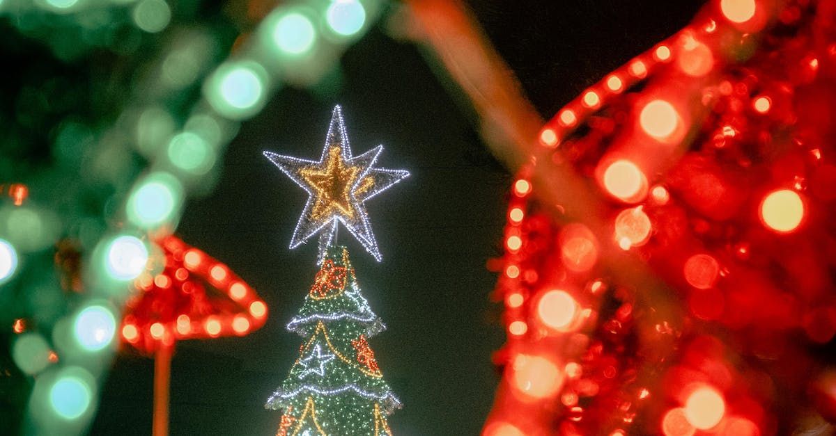 A christmas tree with a star on top of it is lit up at night.