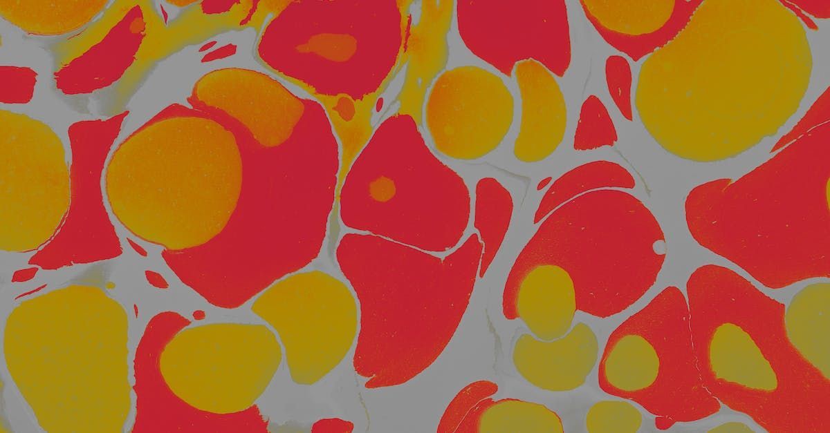 A close up of a red and yellow pattern on a white surface.