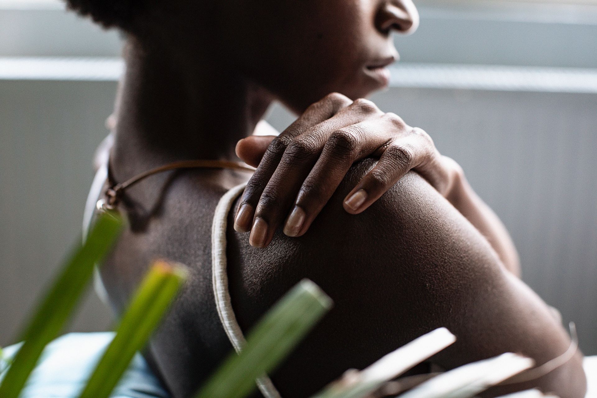 Woman rubbing sore shoulder