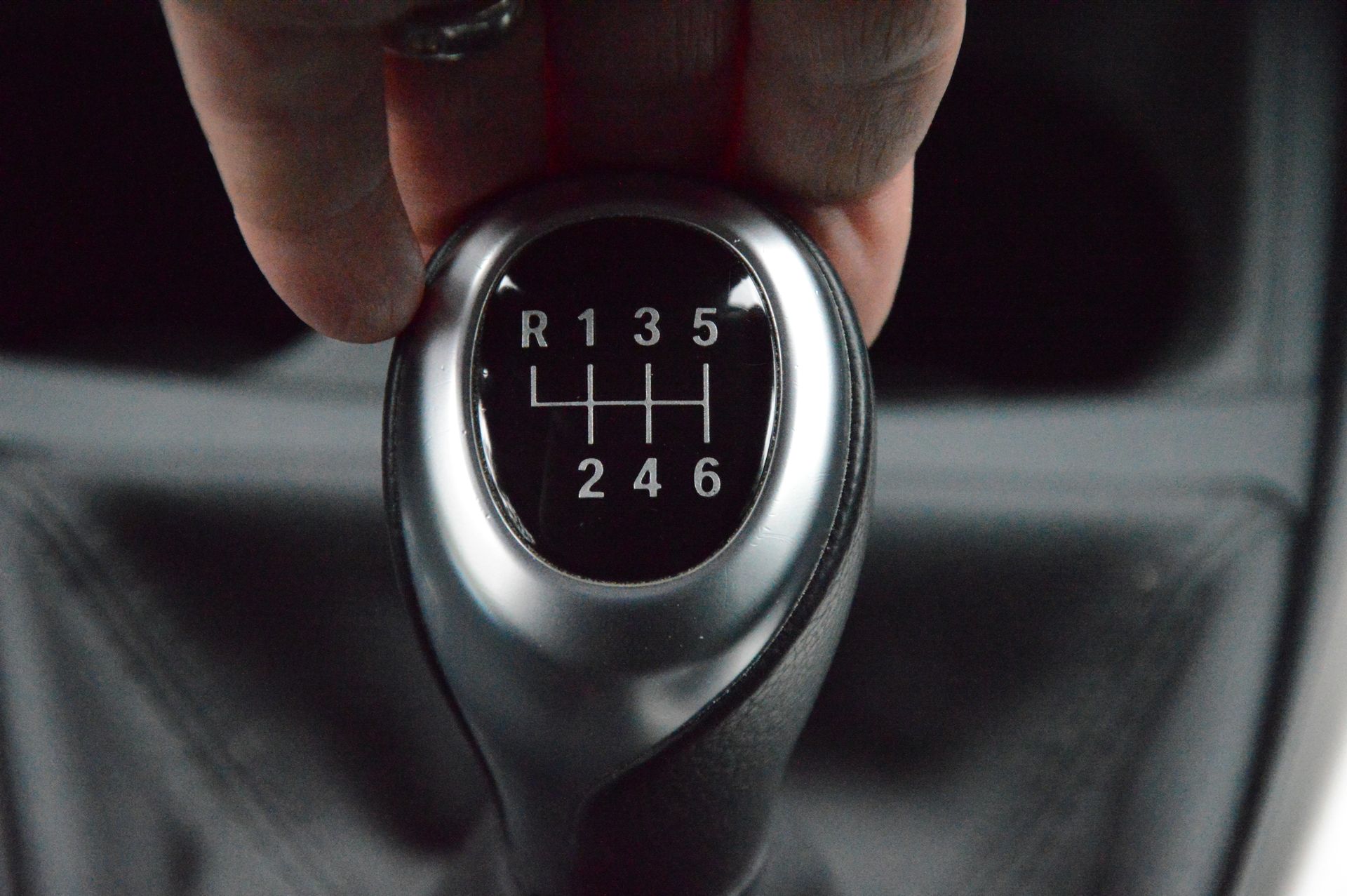 a person is holding a car shifter that says r135 4h 246