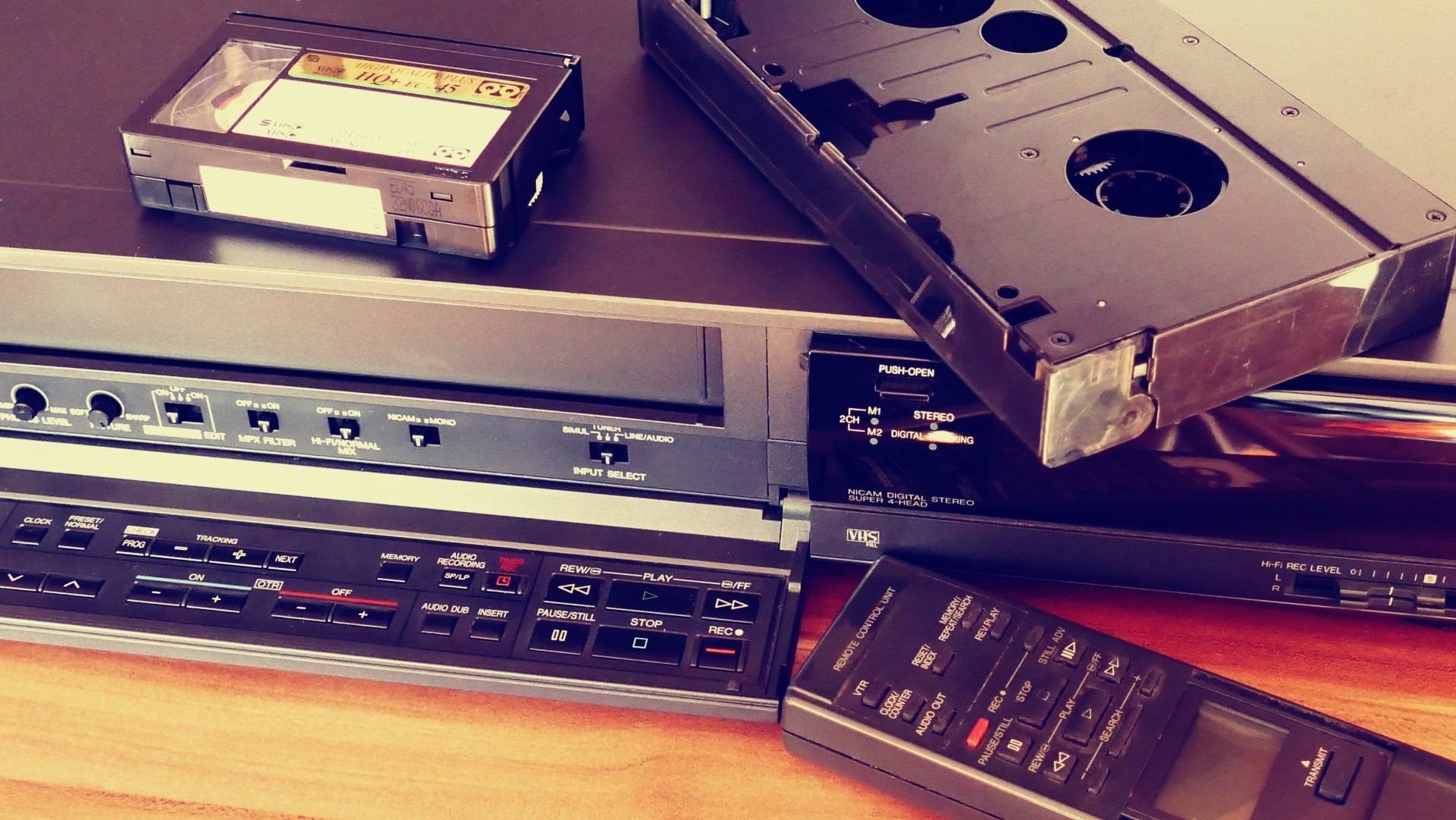 A vhs tape laying on top of a remote control